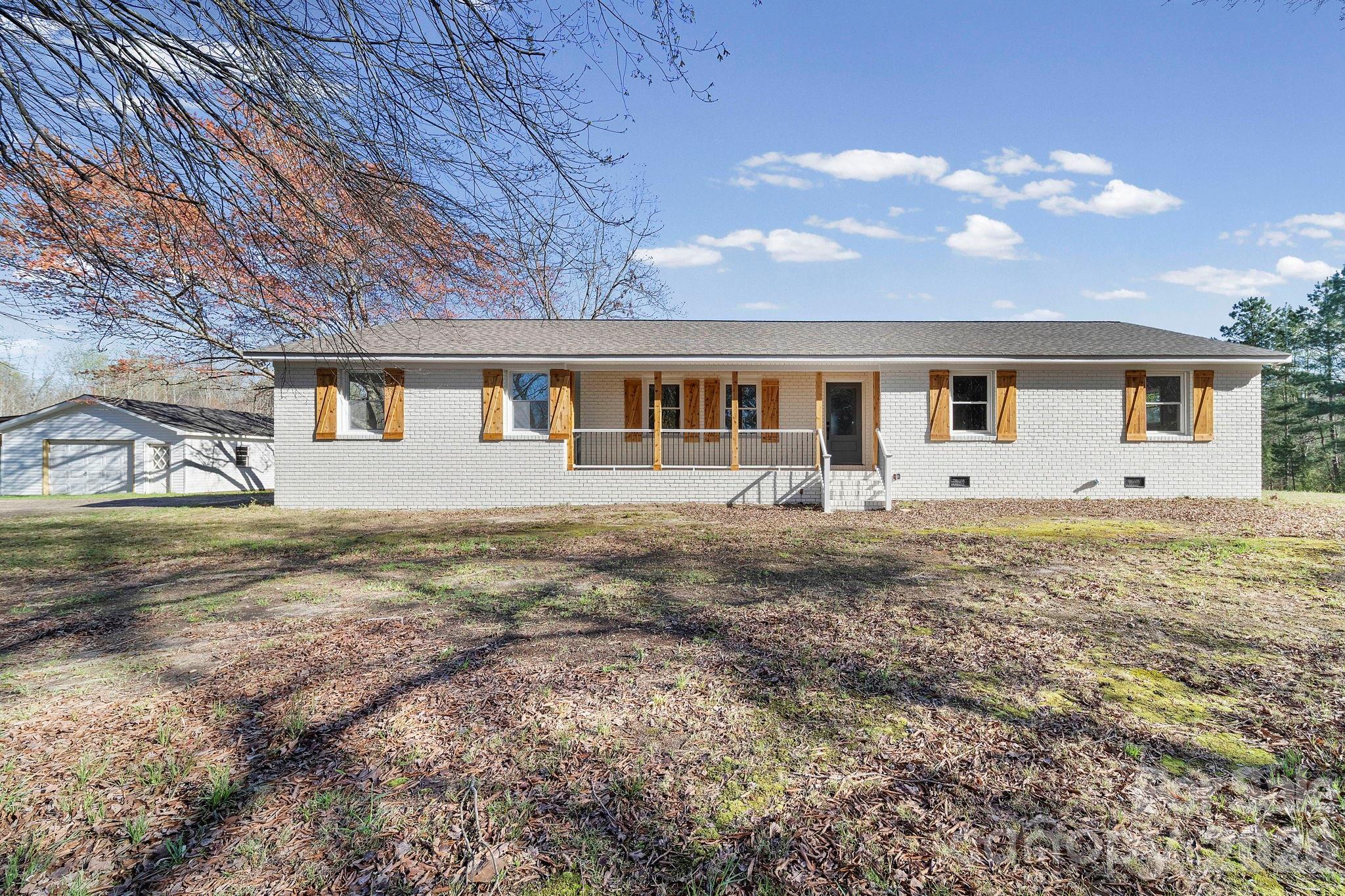 Enjoy country living in this beautifully renovated 3-bedroom, 2-bath all-brick home set on 9+ private acres surrounded by mature oak and magnolia trees. A gated driveway welcomes you to the property, offering both privacy and charm. Inside, the home features a spacious open floor plan with a dedicated laundry room and a well-appointed kitchen with accent lighting and granite countertops. The owner’s suite includes a private bath with shower and a walk-in closet for added comfort. Outside, the property offers rear screened porch for morning coffee.  And plenty of room for hobbies, storage, or business use with a 24x40 workshop and an additional 20x24 outbuilding. This property combines modern updates with quiet country space—perfect for those seeking privacy, room to roam, and functional outbuildings. Windows updated May 2026. BUFORD SCHOOLS AND NO HOA!