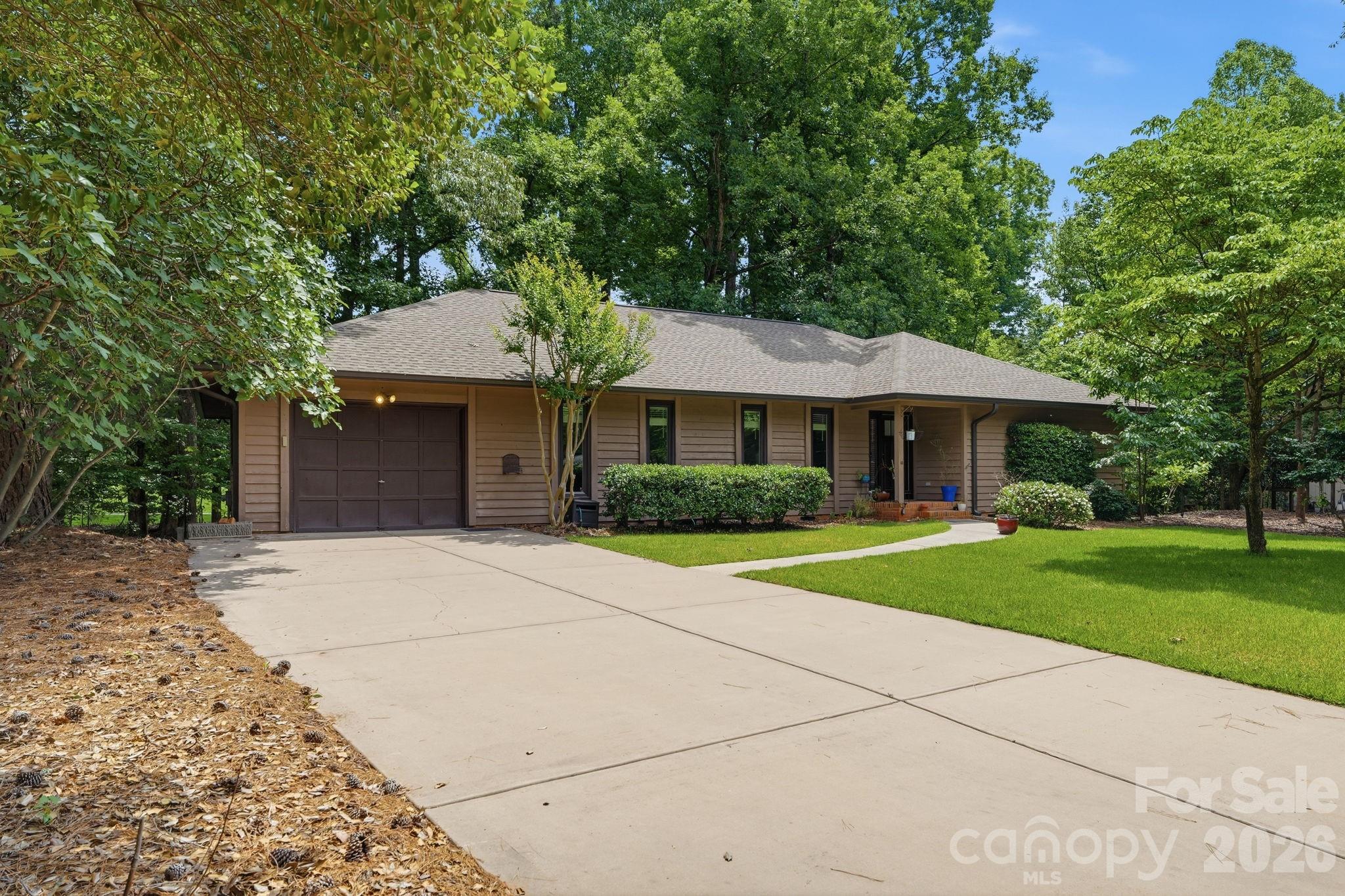 Wonderfully updated RANCH in the Sought-After Gated Community of River Hills on Lake Wylie!
From the moment you step through the door, this home just feels right. Bright, open, and full of warmth — it lives so much larger than you'd expect and flows beautifully whether you're hosting a houseful of friends or enjoying a quiet evening with family.
With 3 bedrooms, 2 baths, a dining room, great room, and a flex room perfect for a home office or den, there's a place for everything and everyone. The layout just works — easy, connected, and made for the way people actually live.
Since purchasing, the owners have loved and invested in this home. Beautiful hardwood floors now run throughout the entire house, fresh paint and updated light fixtures and fans give every room a polished, move-in-ready feel, they invested in professional landscaping that  transforms the outdoor spaces into something truly special. The crawl space has been fully encapsulated for peace of mind, the deck has been tiled and the area beneath it enclosed for added versatility, and a newer refrigerator conveys with the home.
The great room with gas fireplace opens to a screened porch — your future favorite spot for morning coffee or evening gatherings. The u-shaped kitchen offers great workspace and storage, and the mudroom with sink and cabinetry keeps life organized. Just outside the laundry room, a convenient drop zone for coats, backpacks, and everyday essentials makes busy family mornings just a little bit easier.
The primary suite features three closets, and every bedroom boasts those charming beadboard/shiplap ceilings that add a warm, designer touch throughout.
And don't overlook the garage — it's a generous single-car space with plenty of extra length to park your golf cart, motorcycle, or store bikes alongside the car. Perfect for the active River Hills lifestyle!
Step outside and you're a short walk to the marina and playground gardens. River Hills offers miles of walking trails, a waterfront park with a sandy beach and pavilion, a country club with golf and two pools, a dog park, and so much more — all within the award-winning Clover School District.
Well maintained, thoughtfully updated, and ready for its next chapter. WELCOME HOME!