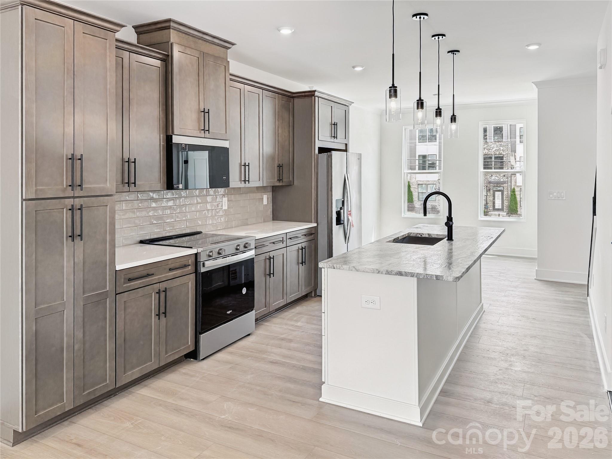 Experience modern luxury in the heart of LoSo, one of Charlotte’s fastest-growing areas. This brand-new, move-in ready Dunbrook floorplan townhome, offers 3 bedrooms, 3.5 baths, and a 2-car garage—with a private en-suite bath in every bedroom, ideal for roommates or guests.
Designed for seamless indoor-outdoor living, the open-concept main level extends from the Great Room to a outdoor living area, while the rooftop terrace provides an elevated space for entertaining or unwinding. The designer kitchen features quartz countertops, soft-close cabinetry, and a spacious island, complemented by hardwood stairs and luxury vinyl plank flooring throughout the main living areas and fourth-floor bedroom.
Additional highlights include durable Hardie Plank siding, crown molding, zoned thermostats for enhanced comfort, and abundant natural light throughout.
Located just two blocks from the LYNX Blue Line at Scaleybark Station, with quick access to South End’s dining, breweries, and Uptown.
Limited-time financing incentives available—contact agent for details.
