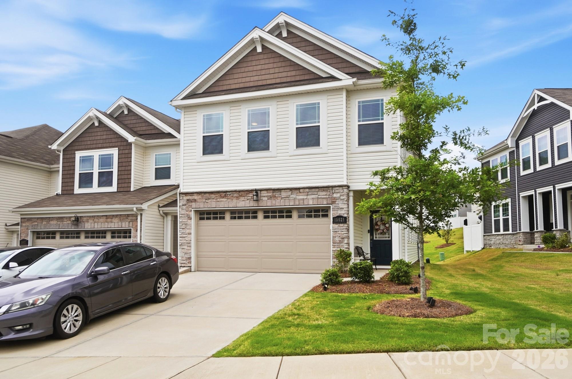 Beautiful like-new end unit townhome in the desirable Porters Row community! This spacious and bright 3 bedroom, 2.5 bath home offers an open concept floor plan with 2,000 square feet of living space, perfect for everyday living and entertaining.  The stylish kitchen features a large island with seating, ample cabinetry, and flows seamlessly into the dining area and family room with fireplace.  Upstairs, the spacious primary suite includes a walk-in closet and bath with large walk-in shower, while two additional bedrooms provide flexibility for guests, office space, or family needs.  Enjoy low-maintenance living with lawn care included, plus a rear patio overlooking community picnic area, attached 2-car garage, and community amenities including walking trails and picnic areas.  Conveniently located near shopping, dining, Lake Wylie, and easy access to Uptown Charlotte and Charlotte Douglas International Airport.