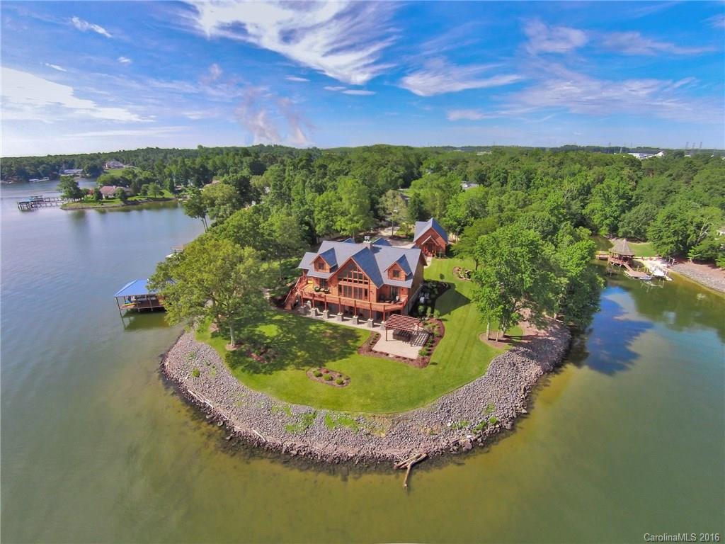 Extraordinary Unique 2015 Custom Built 6275sq.Timber Home on Gated Priv Peninsula w/3 Flrs of Breathtaking Panoramic Main Channel Views!Over 600ft of Shoreline~Spectacular 3 Sty Stacked Stone FP~Wall of Wnds~Loaded Gourmet Kit~Scrn Prch w/Built-in Grill & Wet Bar~Mst Ste w/Luxury Bth~Lwr Lvl Fam Rm w/FP & Tile Inlaid Flrs~Workout Rm w/Sauna & Wet Bar~Ofc~Hot Tub~Cust Dock w/2 Lifts & Trex Deck~Priced Well Below Cost to Build!For 3D tour Go to https://my.matterport.com/show/?m=QshCtUs7nZS&brand=0