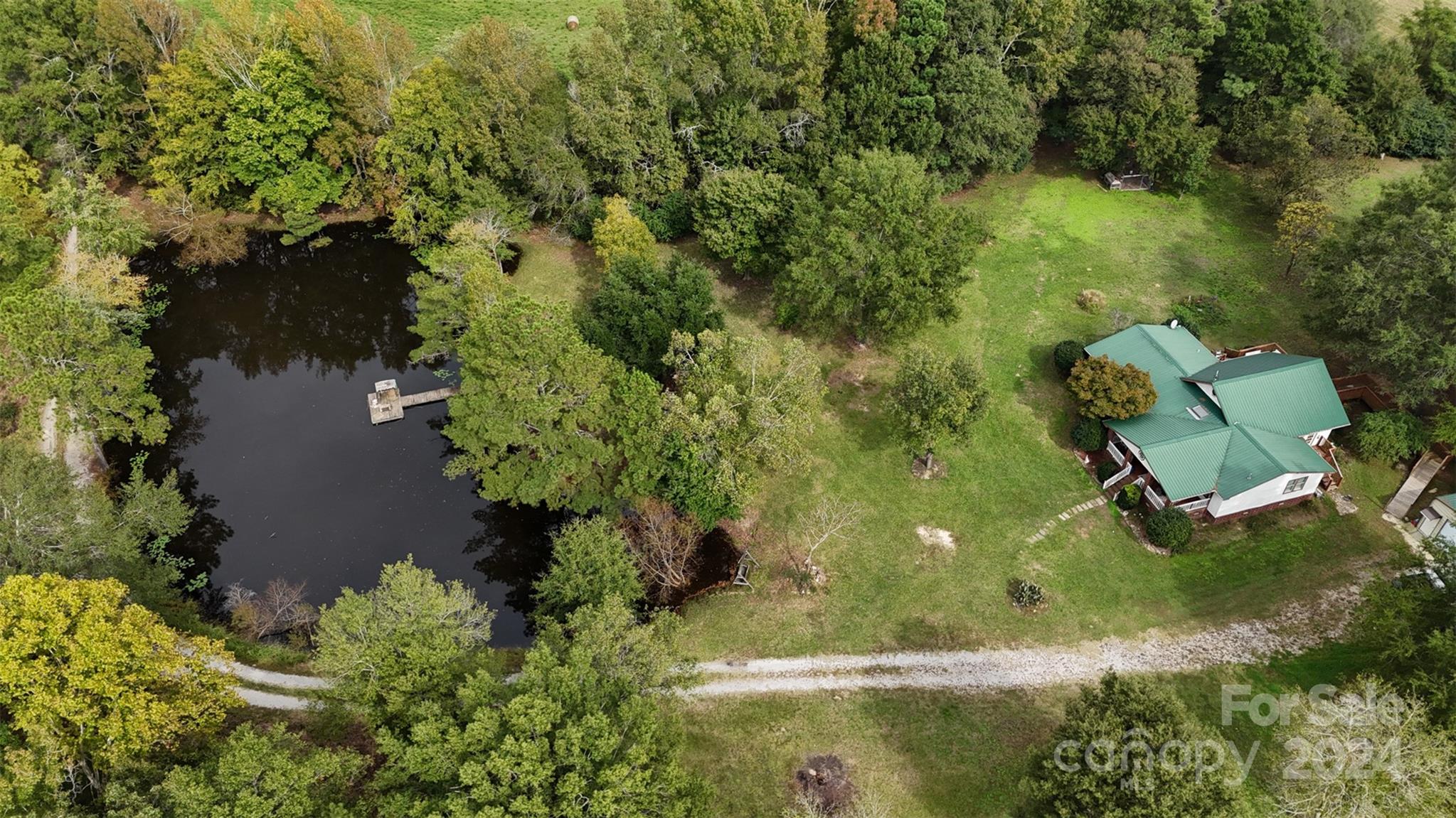 Immerse yourself in the gentle cadence of rural life. This property offers a respite from the hustle and bustle of urban living, opening the door to a world where tranquility and self-sufficiency reign. The home provides cozy homestead and a sprawling agricultural estate, an array of possibilities limited only by your imagination. Two Parcels-The home sits on 5 acres, while the other 35.62 acres leads to a grand total of 40 plus acres. The home features an open floor plan, stainless steel appliances, Large Great Room with gas fireplace. Detached garage and work shed with electricity. HVAC new in 2021, 50 year warranty metal roof Get Outdoors and go fishing in the two stocked ponds, wildlife and hunting opportunities, lead to Beautiful Sunsets on the deck. Lancaster County/SC Taxes. Only 3 miles from Hwy 521, Easy commute to Charlotte within 45 minutes.