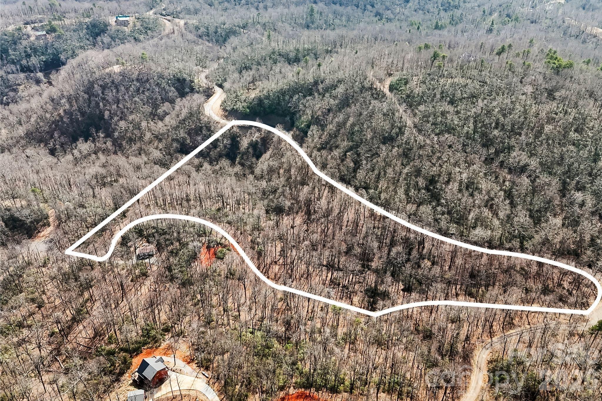 Build the mountain home you have been dreaming of on this private and expansive 12.32 acre lot in the gated Laurel Mountain Preserve community.  Centered on a small creek drainage between Laurel Mountain Trail and Council Bluff Trail, well maintained neighborhood roads offer easy access to virtually the entire lot.  Gentle terrain, buried power, and a few roughed-in driveway cuts on the Council Bluff side offer beautiful build sites with abundant & sunny southern exposure and filtered winter views.  Surrounded by beautiful mature hardwood trees, this peaceful lot will become your private mountain oasis, yet it is only 30 minutes from Lake Lure and 45 minutes to Asheville.  With the flexibility to subdivide into 5 acre minimum parcels, this property offers true multi-generational or family compound possibilities.  Bring your house plans and discover how easy your western NC mountain living dreams can come to life.