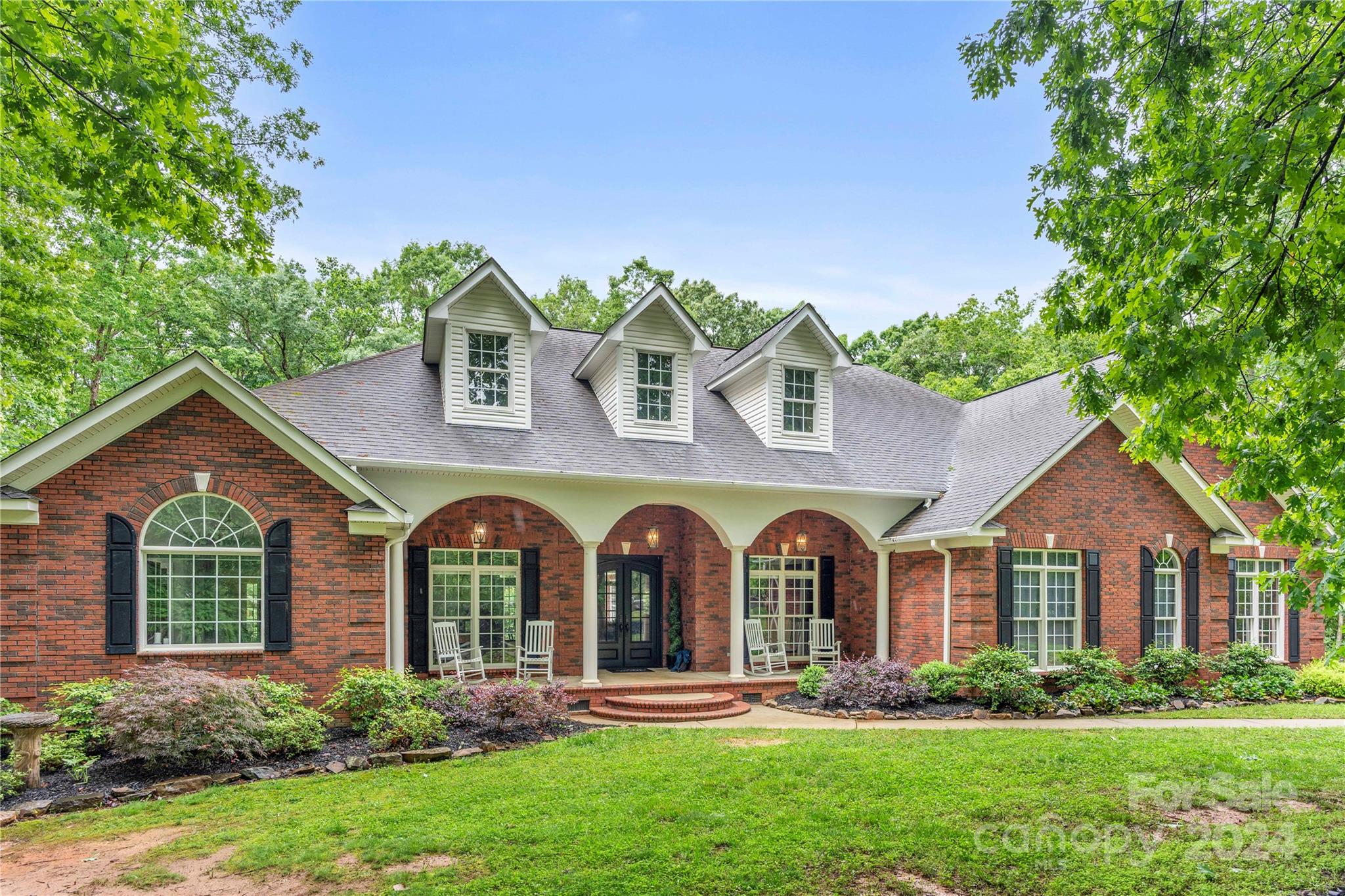 Stunning home, you will fall in love as you come down the long driveway of this 2-plus acre estate! Enter through the beautiful custom front door. The main level features an office, dinning room, living room, great room & a masterfully positioned kitchen adorned with custom countertops, ample cabinet space & stainless steel appliances. Custom trim, built-ins and quality finishes throughout. This home has a split bedroom plan with the primary bedroom on the south wing, & 2 other bedrooms on the north wing. Need more space? Check out the upper level, fitted with a 4th bedroom, full bath and an exercise/flex room. Don't miss the enormous walk in attic. If you love outdoor living, welcome home! Step out on to the long back porch, overlooking the amazing pool and pool deck, a beautifully landscaped yard, offering privacy and seclusion.  If the 3-car attached garage is not enough, check out the massive detached 2 bay garage, ready with RV hookups and a conditioned flex space with full bath.