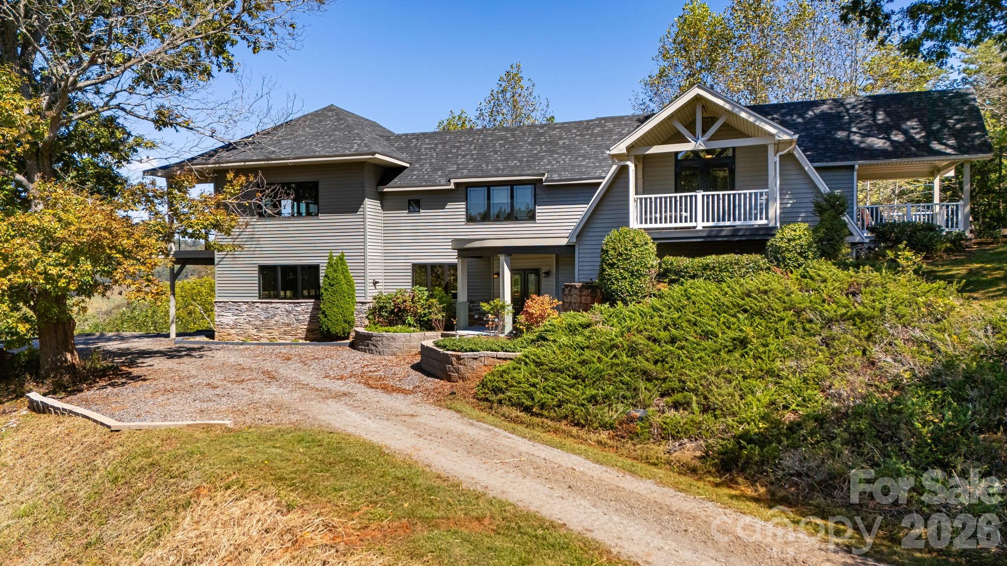 Market adjustment, now lowered by $40,000. $94K lower than the original listing price. Well below market value, you gain instant equity!  Exceptional 20 plus acre Estate in Scenic Mars Hill, NC Discover this stunning estate nestled in Madison County NC, known as "The Jewel of the Blue Ridge Mountains." Started in 2000 with a small 990 sq ft cabin, then the home was expanded and newly constructed in 2017 to the present home and floor plan. Enjoy breathtaking 270-degree long-range mountain views and spectacular sunsets. The meticulously manicured grounds feature a small pasture and a vibrant array of flowers that attract pollinators. With NO HOA and NO restrictions, you have the freedom to embrace country living, on your choice of two balcony decks! A small, fenced coop behind the house has previously served as a garden for fresh herbs and berries. Land is surveyed for a small development of 10 homes, if you desire STR/VRBO additional income. There are numerous potential home sites identified in the survey, also perfect for building a separate family guest quarters. The current home expansion was completed in 2017 with a finished heated and cooled area of 3391 sq ft. When combined with the decks, garage, garage utility flex space, and all non-HLA areas, the home has a total of 5197 sq ft. A 1/4-mile driveway ensures privacy, and if desired, a paved road for your luxury or classic vehicles can be easily installed, but is not needed, a paving estimate is available. Any car can access the home easily. Conveniently located just 8 minutes from Mars Hill Ingles grocery store and college, Hot Springs 35 minutes, 17 minutes to Weaverville Publix, 26 minutes to downtown Asheville, and 40 minutes to the Asheville airport. Escape to the serene beauty of the Western NC Mountains and claim your own generational private estate. Experience peace, tranquility, and the stunning four-season colors of this expansive mountain view from your private, custom Trex wood terrace, with truly breathtaking year-round views! Make this estate your “Jewel of the Blue Ridge Mountains”.  Please review the extensive feature list, which includes High-Quality construction throughout the home. A Matterport home tour link is also available. The mountains are calling and I must go! Schedule your showing today to preview this turn-key ready WNC mountain estate!