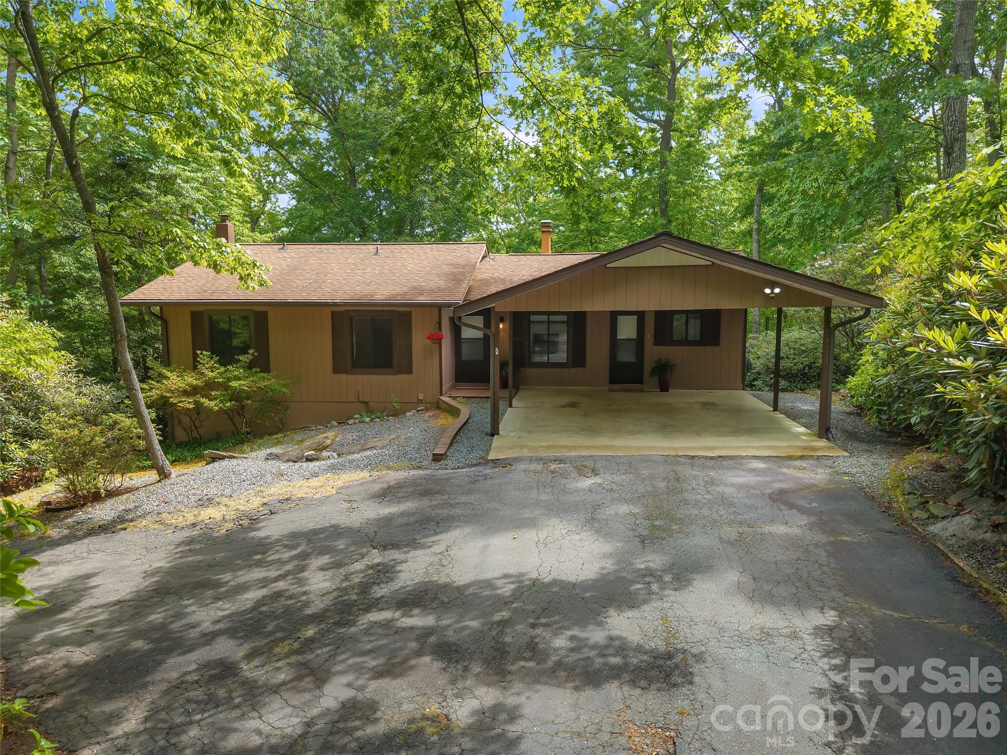 This well-maintained 3 bedroom, 2 bathroom home is conveniently located close to town and offers distant partial and seasonal mountain views. The main level includes comfortable living areas and a sunporch that brings in natural light and overlooks the long-range scenery. Luxury vinyl plank flooring was added throughout the upper level in 2022.
The lower level provides a flexible area suitable for a workshop, den, office, or hobby space, and features a sliding glass door for added light and exterior access. Outside, the property offers a manageable yard with established planting beds, along with a circular driveway and two-car carport for easy entry.
Recent updates include a new HVAC system with basement dehumidifier installed in August 2025 and a new refrigerator added in October 2025
