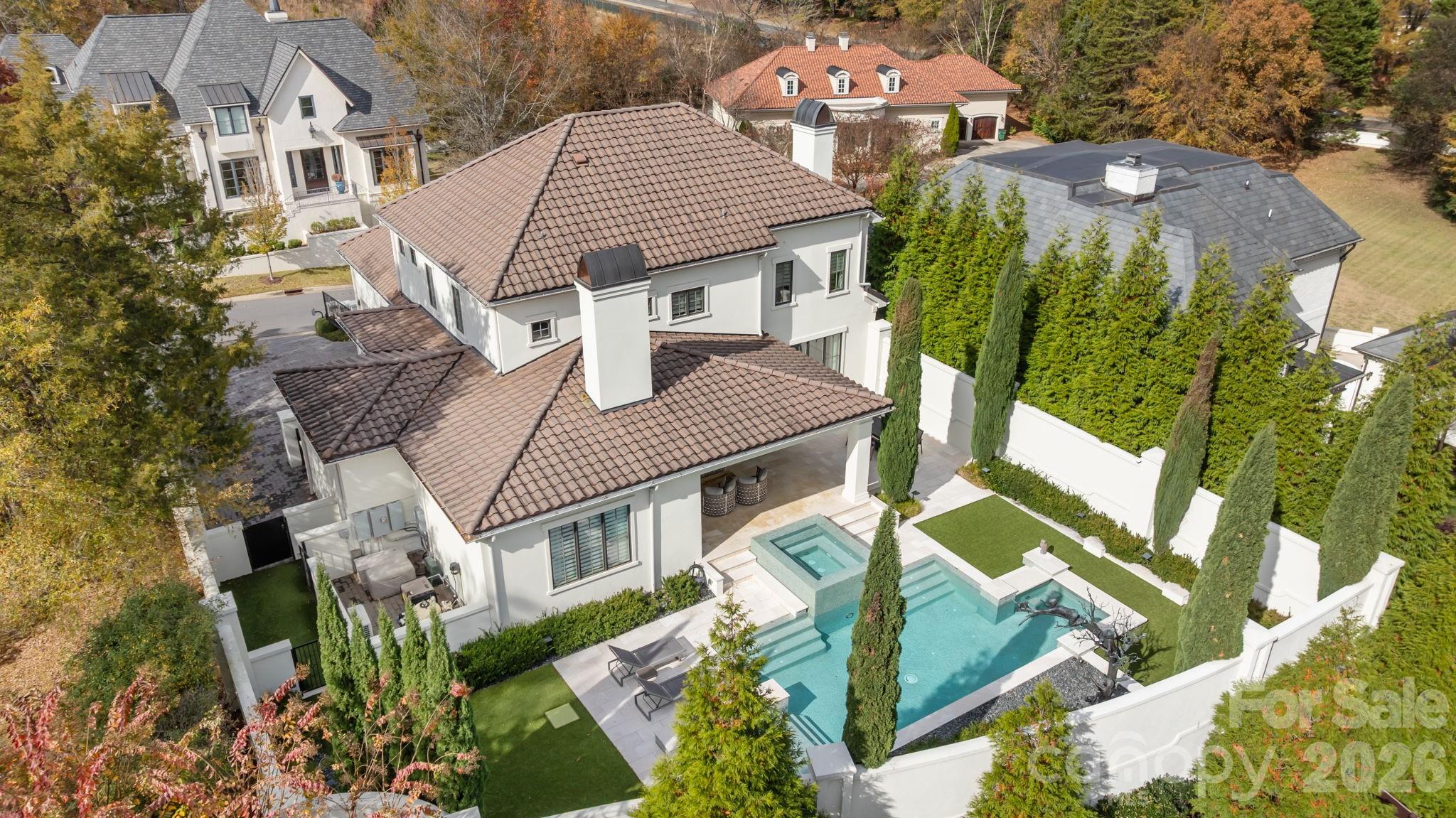 Stunning modern home in the privately gated Seven Eagles community. Designed with clean lines and high-end upgrades throughout, this home offers a bright, open layout perfect for everyday living and entertaining.  The main level living areas are all spacious and open to the private backyard retreat with floor to ceiling windows and doors providing incredible natural light. The primary suite on the main floor includes generous walk-in closets & a spa-like bathroom. The upper level includes 2 secondary bedroom suites each with their own bathrooms along with a  a bonus room providing flexibility for your own specific needs. The entire property has been immaculately maintained. Sleek cabinetry, high-end finishes, Lutron lighting & a heated/cooled basement storage room are just a few of the many one of its kind features this property boasts. The incredible outdoor living space includes a private pool and expansive patio —ideal for relaxing or hosting family and friends. A rare opportunity for modern luxury in a gated, sought-after neighborhood.