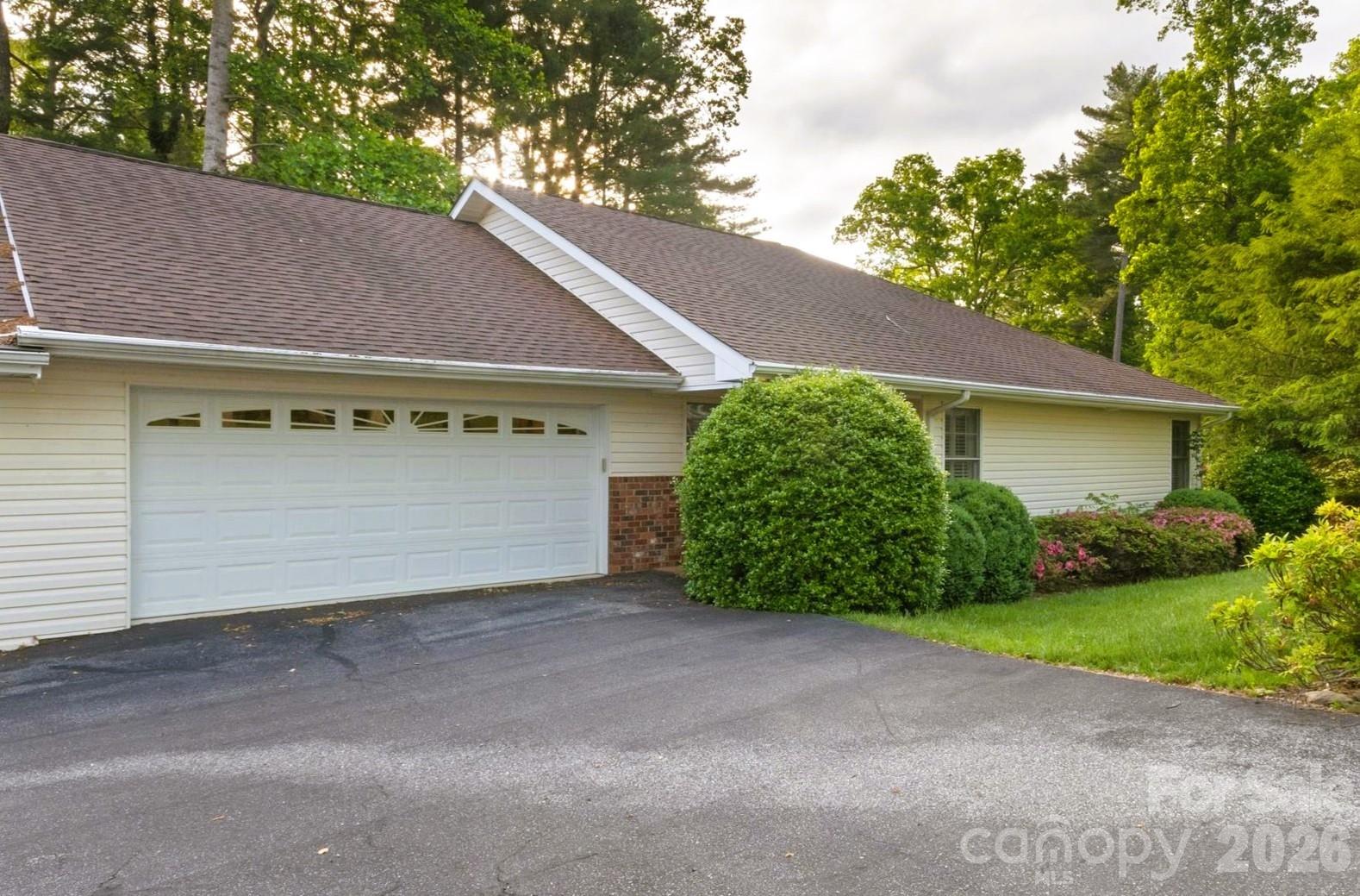 Enjoy easy one-level living just minutes from downtown Hendersonville in this inviting home located in a pet-friendly community close to dining, shopping, parks, and medical services. Vaulted ceilings and skylights fill the home with natural light, while the flexible layout includes a den or office, large bedrooms, and a spacious primary suite with a walk-in closet. Relax year-round in the three-season room overlooking the back deck. Additional features include a laundry room, attached two-car garage, and extra storage or workshop space off the garage. The HOA maintains the yard, helping simplify daily life so you can spend more time enjoying everything Hendersonville has to offer. Schedule your showing today!