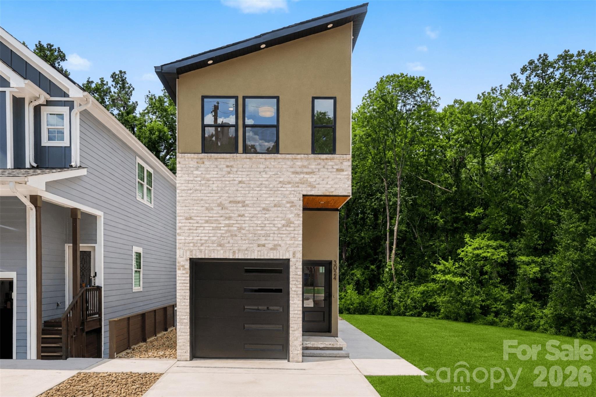 Experience thoughtfully designed modern living in this exceptional custom home, where contemporary architecture and quality craftsmanship come together seamlessly. Designed by an architect with both style and functionality in mind, every space maximizes natural light, flow, and everyday living. Ideally located just minutes from Uptown Charlotte, South End, NoDa, and Charlotte Douglas International Airport, this home offers modern luxury in one of Charlotte's fastest-growing areas.

The open-concept floor plan is filled with natural light from oversized windows and features hardwood floors, designer finishes, and a sleek kitchen with premium appliances, stylish cabinetry, and generous entertaining space. The home offers four bedrooms, three full bathrooms, and two half bathrooms, including a spacious primary suite with a walk-in closet and an elegant en-suite featuring a large tiled walk-in shower.

A standout feature is the rooftop level, complete with a covered bonus room ideal for a lounge, home office, media room, or fitness space, plus an expansive rooftop terrace perfect for entertaining, dining, or relaxing outdoors. The finished lower level adds exceptional flexibility with its own bedroom, full bathroom, full kitchen, and living area, making it ideal for multigenerational living, extended guests, or a private retreat.

Outside, enjoy a fenced backyard and private deck. Located on a quiet street near exciting new residential and commercial development along the West Boulevard corridor, this home combines sophisticated design, versatile living, and an unbeatable Charlotte location.