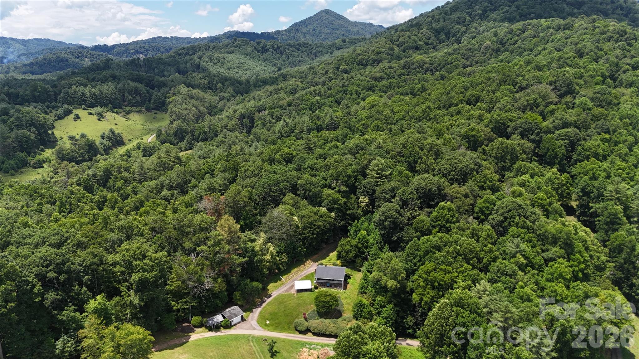 BACK ON THE MARKET THROUGH NO FAULT OF THE PROPERTY! The previous buyer's job transfer unexpectedly fell through, creating a second opportunity to own this exceptional mountain retreat. To help ensure a smooth transaction, a brand-new survey has already been completed, allowing for a quicker and more efficient closing process.

Welcome to 15.59 acres of unrestricted mountain property offering privacy, usable land, and endless potential in the heart of Burnsville. This unique property combines a comfortable home with the kind of acreage that is becoming increasingly difficult to find, especially with this level of accessibility and versatility. Tucked into a peaceful setting, the property provides a rare opportunity to enjoy both seclusion and convenience while being surrounded by the natural beauty of Western North Carolina.

The home features 3 bedrooms and 1.5 baths with a functional layout and inviting living spaces, making it ideal for full-time living, a mountain getaway, or an income-producing rental. The interior offers a warm and comfortable atmosphere with plenty of opportunity to make it your own.

The owners have taken excellent care of the home and completed numerous updates, making it move-in ready. Major improvements include a new roof installed in 2021, an updated heat pump in 2021, a new well pump and filtration system, a convenient spout providing access to natural spring water, and a new hot water heater installed in 2023.

The land is where this property truly shines. Featuring multiple areas of usable terrain, established logging roads, and excellent accessibility throughout, the property lends itself to a variety of uses. Whether you're exploring future homesites, riding ATVs, creating trails, or simply enjoying the peaceful surroundings, you'll appreciate the versatility and usability of the acreage.

This property is perfectly suited for a homestead, mini farm, private mountain retreat, recreational property, or multi-generational estate. With no restrictions, the possibilities are wide open. Build additional homes, add guest cabins, bring animals, create gardens, establish income-producing opportunities, or simply enjoy the freedom and privacy that unrestricted land provides.

Conveniently located while still offering a true sense of seclusion, you'll enjoy peaceful mountain living with easy access to Burnsville's shops, restaurants, outdoor recreation, and community amenities.

Properties offering this combination of unrestricted acreage, updated home, established road systems, usable land, and mountain privacy are becoming increasingly rare. Don't miss your second chance to own this remarkable Western North Carolina property.