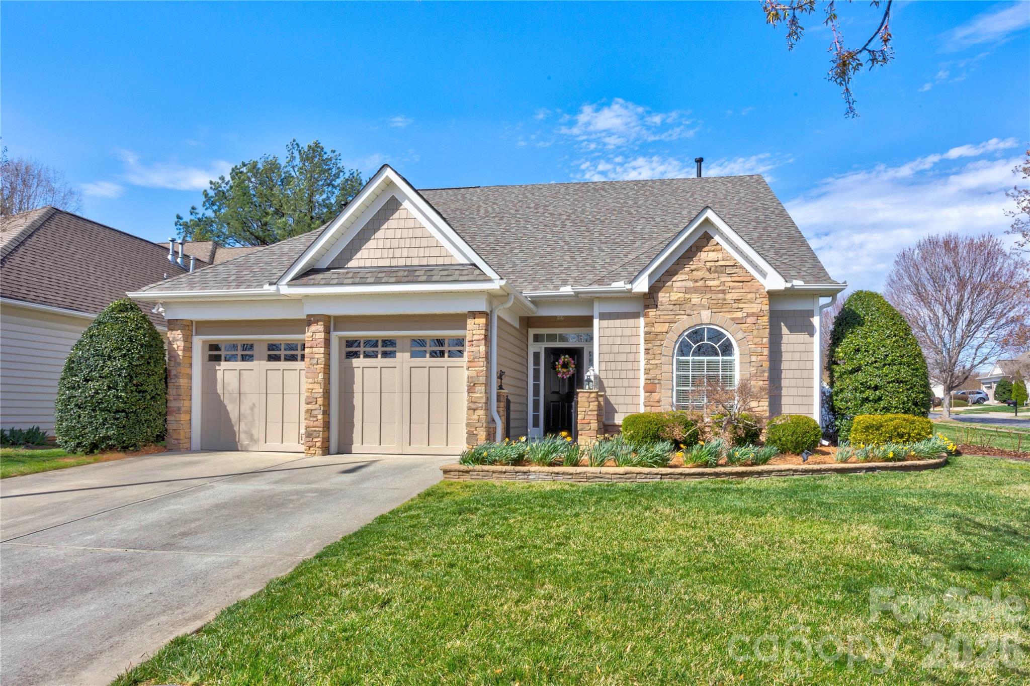 This home has been meticulously maintained and thoughtfully updated!  Welcome to Cobblestone, a small neighborhood of patio homes within the always popular Laurel Park subdivision.  It enjoys the amenities of Laurel Park which include a beautiful club house, a large pool to support the neighborhood swim team, a fishing pond, tennis and pickle ball courts, a playground and picnic area.  Plus, the added benefit of a very reasonable, year long lawn maintenance plan that is included in the HOA for an easy life-style.  The open floor plan boasts a spacious dining room, a kitchen with  a warm and inviting breakfast area and a 2-story family room.  Gleaming engineered hardwood floors throughout the main level create a seamless flow. The kitchen is amazing with a honed granite counter top, a tile backsplash, gas range/oven, stainless steel appliances and hood.  The family room features a floor to ceiling stone surround at the corner fireplace with a new mantel and gas fireplace insert.  All new light fixtures have been added throughout the home with many recessed can lights for a cozy atmosphere.  There is abundant storage throughout the home with custom designed cabinetry in all closets, pantry, laundry room and garage.  All the big ticket items have been replaced in the last few years with a New Certainteed Architectural ROOF in 2025, HVAC units replaced in 2023 and 2022.  A gas hot water heater was added in 2025.  The primary suite boasts a beautiful view of the lush and fenced back yard with seasonal plantings, a rose garden, a peach tree and blueberry bushes.  The primary bath has been updated with new plumbing fixtures, light fixtures and a new hybrid frameless shower.  Upstairs you will find two comfortable sized bedrooms, a spacious full bath and loft area perfect for relaxing or an in-home office.  Just minutes to I-85 for commuters and to all local shopping and amenities.  Make your appointment today!