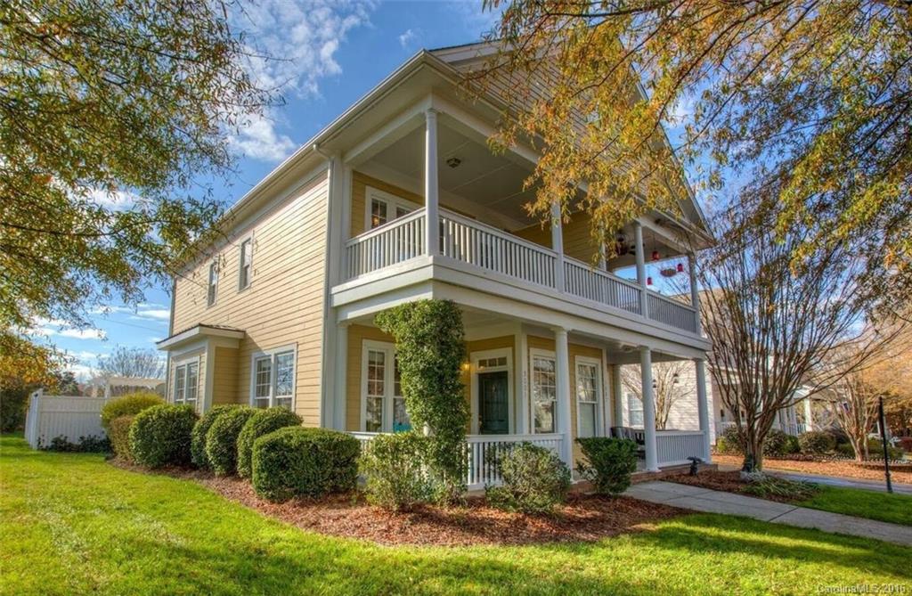Move into this unique Charleston style home on a large corner lot! Home features double front porches - perfect for relaxing&conversing the old fashion way, open floor plan w/ fireplace & builtins in great room, custom crown molding throughout, granite counters &tile backsplash in kitchen, two master suites, NEW carpet, and private fenced backyard backed to open space. Easy walk to pool, parks, dining, shopping, gym, school & library. Quick drive to Charlotte! Home inspection completed!