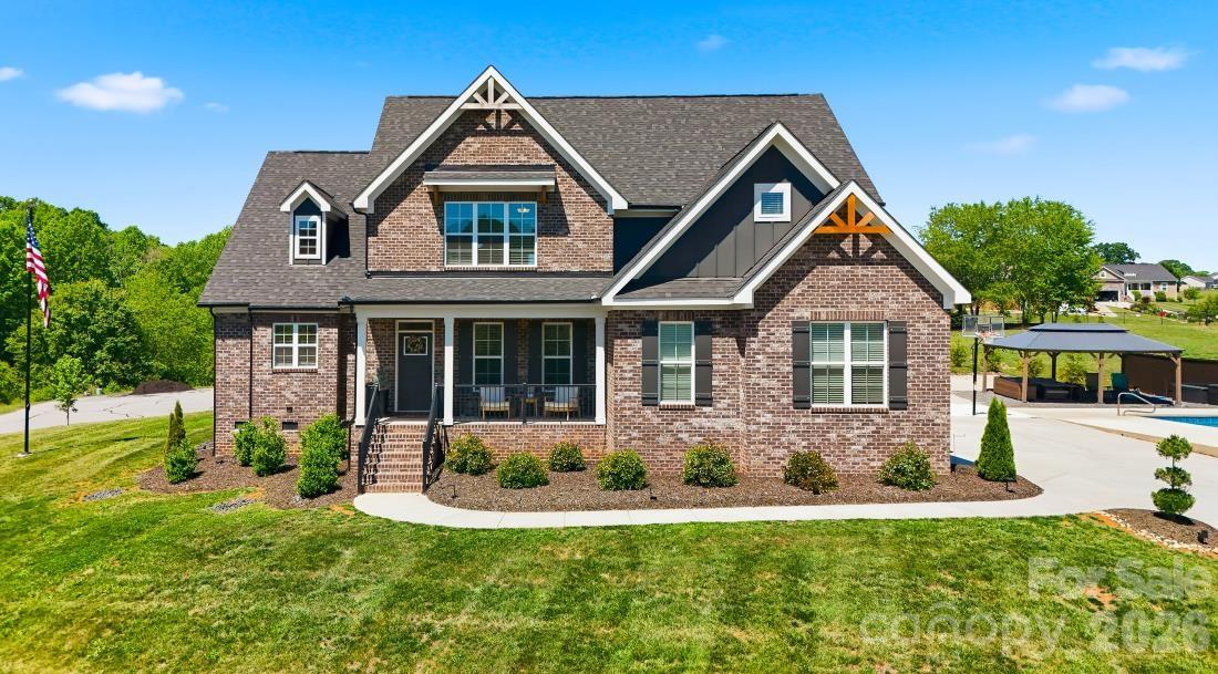 Exceptional craftsmanship and refined living define this stunning 4-bedroom, 4-bath residence located in a prestigious gated community in Granite Falls with exclusive lake access. Perfectly positioned on a gently elevated homesite, this home offers both privacy and impressive curb appeal. 
Inside, a thoughtfully designed open floor plan showcases soaring ceilings, abundant natural light, and upscale finishes throughout. The chef’s kitchen is beautifully appointed with crisp white cabinetry, stainless steel appliances, expansive countertops, and seamless flow into the main living spaces—ideal for both everyday living and elegant entertaining.
The great room features a dramatic vaulted ceiling and a striking fireplace, creating a warm yet sophisticated gathering space. A well-appointed dining area and spacious bedrooms provide comfort and versatility, while multiple full baths offer convenience for family and guests alike. 
Step outside to your own private resort-style retreat. The in-ground pool is surrounded by an expansive patio, lounge areas, and a covered outdoor space designed for relaxation and entertaining at the highest level. Professionally landscaped grounds enhance the home’s serene and inviting atmosphere. 
Residents enjoy the security and exclusivity of a gated community along with access to the lake, offering a lifestyle that blends luxury, recreation, and tranquility. More photos to come!