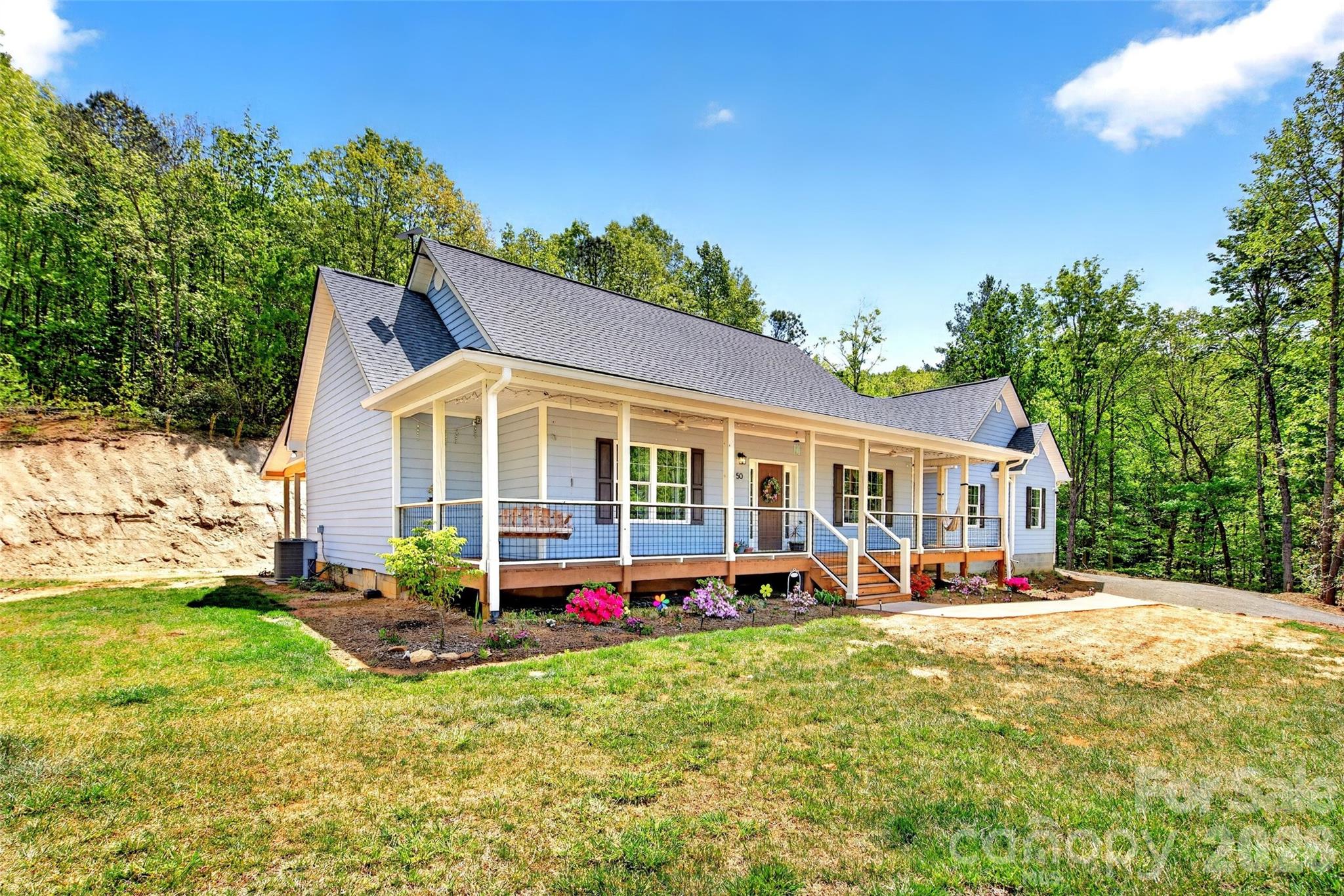 Mountain living at its best in gated Catawba Falls Preserve. Built in 2022, this thoughtfully designed one-level 3 bedroom, 2 bath home with a large study/bonus room sits on nearly 4 private acres with peaceful mountain views and the added benefit of dedicated recreation zone that cannot be built on, creating the feel of an even larger flat usable yard. Located with a Black Mountain address in McDowell County, you’ll enjoy the convenience of lower county taxes while still being just minutes from everything Western North Carolina has to offer.

Designed for both comfort and functionality, this home features granite countertops, wooden Koch soft-close cabinetry throughout, under-cabinet lighting in the kitchen and laundry, and a new stove with air fry and convection options. The spacious garage includes 240v electrical, while the home is already wired for CCTV security and a full home audio system for seamless modern living.

Extensive recent upgrades make this property truly turnkey, including a Quiet Run whole-home generator, in-ground 500-gallon propane tank with backup heat access, hybrid 80-gallon smart heat pump water heater, whole-home HEPA air filtration system, Smart Ecobee thermostats with 3-zone comfort settings, upgraded pressure tank with spin-down water filtration, and an outdoor grilling station with power.

Outside, enjoy excellent landscaping with native trees, shrubs, and bulbs, a quarter-acre garden, concrete pad and sidewalk near the driveway, and peaceful outdoor spaces designed to take full advantage of the mountain setting. Privacy, usability, and quality improvements come together to create a home that feels both elevated and effortless.
