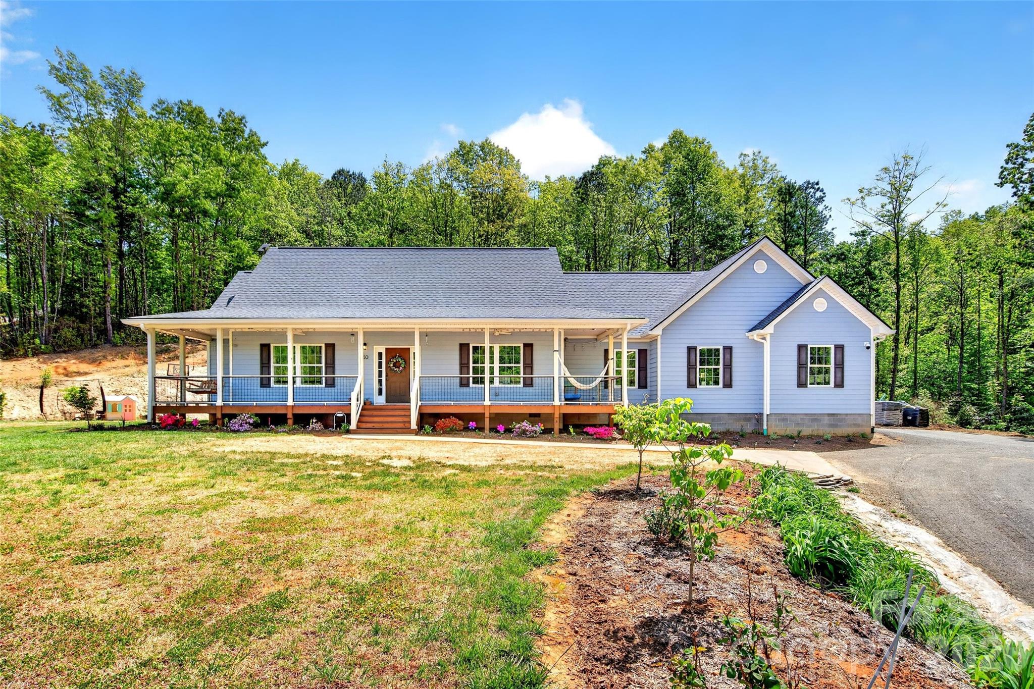 Mountain living at its best in gated Catawba Falls Preserve. Built in 2022, this thoughtfully designed one-level 3 bedroom, 2 bath home with a large study/bonus room sits on nearly 4 private acres with peaceful mountain views and the added benefit of dedicated recreation zone that cannot be built on, creating the feel of an even larger flat usable yard. Located with a Black Mountain address in McDowell County, you’ll enjoy the convenience of lower county taxes while still being just minutes from everything Western North Carolina has to offer.

Designed for both comfort and functionality, this home features granite countertops, wooden Koch soft-close cabinetry throughout, under-cabinet lighting in the kitchen and laundry, and a new stove with air fry and convection options. The spacious garage includes 240v electrical, while the home is already wired for CCTV security and a full home audio system for seamless modern living.

Extensive recent upgrades make this property truly turnkey, including a Quiet Run whole-home generator, in-ground 500-gallon propane tank with backup heat access, hybrid 80-gallon smart heat pump water heater, whole-home HEPA air filtration system, Smart Ecobee thermostats with 3-zone comfort settings, upgraded pressure tank with spin-down water filtration, and an outdoor grilling station with power.

Outside, enjoy excellent landscaping with native trees, shrubs, and bulbs, a quarter-acre garden, concrete pad and sidewalk near the driveway, and peaceful outdoor spaces designed to take full advantage of the mountain setting. Privacy, usability, and quality improvements come together to create a home that feels both elevated and effortless.