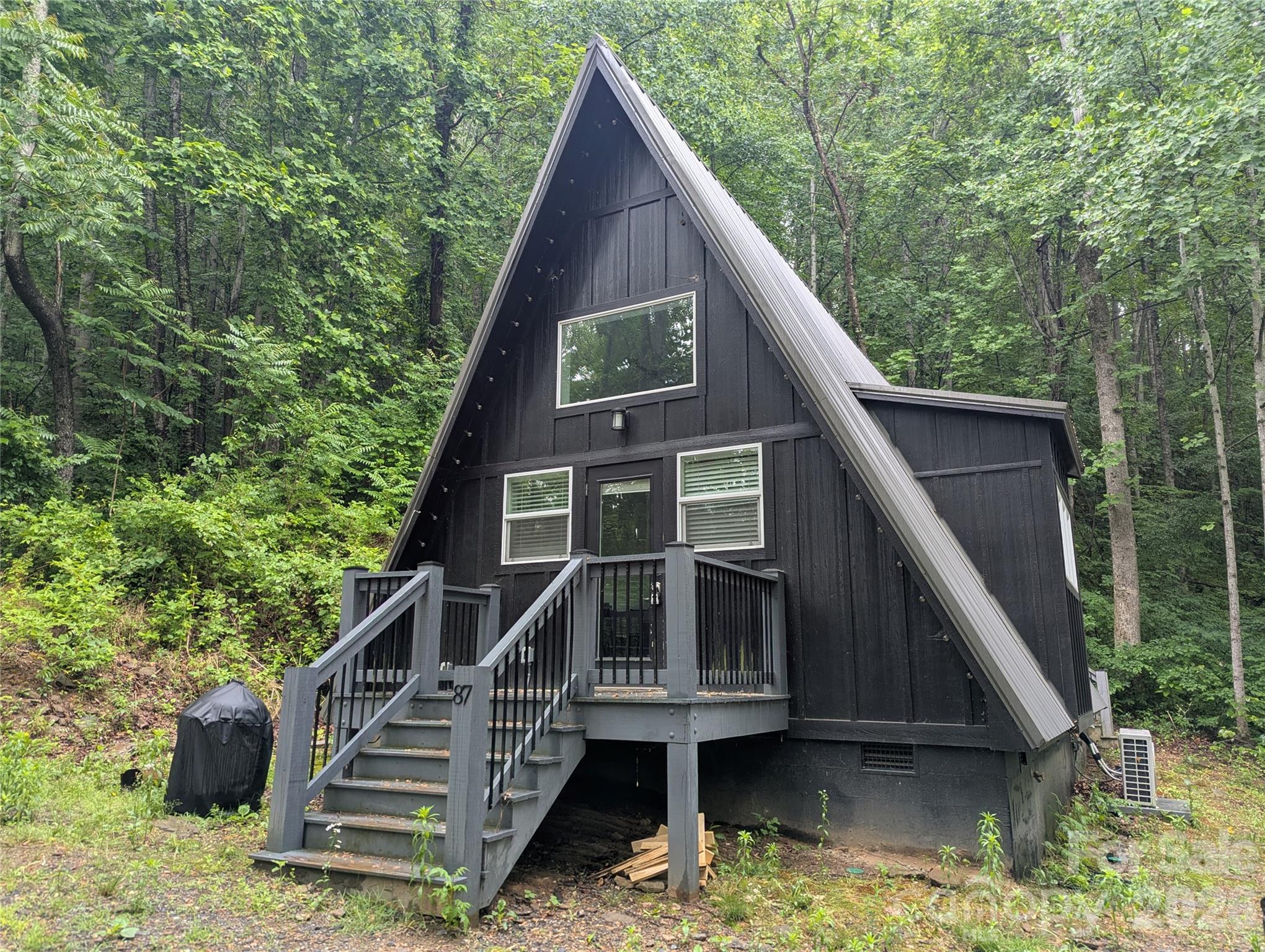MULTIPLES OFFERS. PLEASE SUBMIT HIGHEST AND BEST BY 9AM FRIDAY MAY 29. Newer A-Frame being sold furnished. Private location in Swannanoa with easy access to Black Mountain, Asheville, and I-40. Formerly used as an AirBnb before foreclosure. Main level is 588 square feet, and upper level is an additional 91 square feet but not counted in the total because the access is via pull-down stairs.