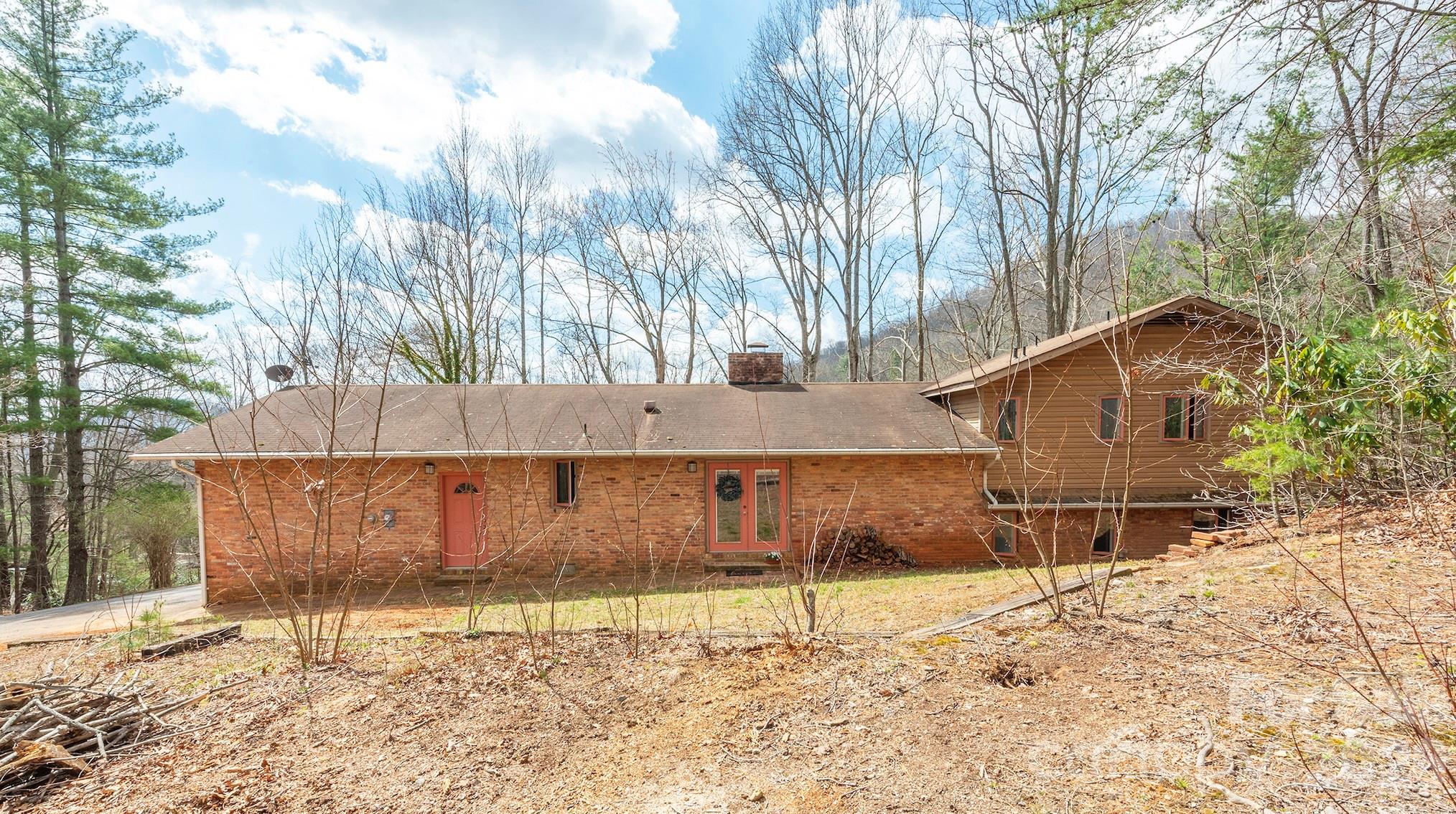 Unlock serious potential with this 4-bedroom, 3-bathroom single-family home tucked away on a peaceful dead-end road adjacent to the Black Mountain Golf Course. This property offers charming vintage touches, and a desirable location with beautiful winter views. Plenty of space for projects in the oversized garage/workshop. The downstairs rec room is ready to host games, movie night, or set up a home gym. Enjoy the rare combination of privacy and proximity to town — with no through traffic, fairway views, and Lake Tomahawk Park just steps away. Black Mountain's charm, outdoor recreation, and proximity to Asheville only sweeten the deal.