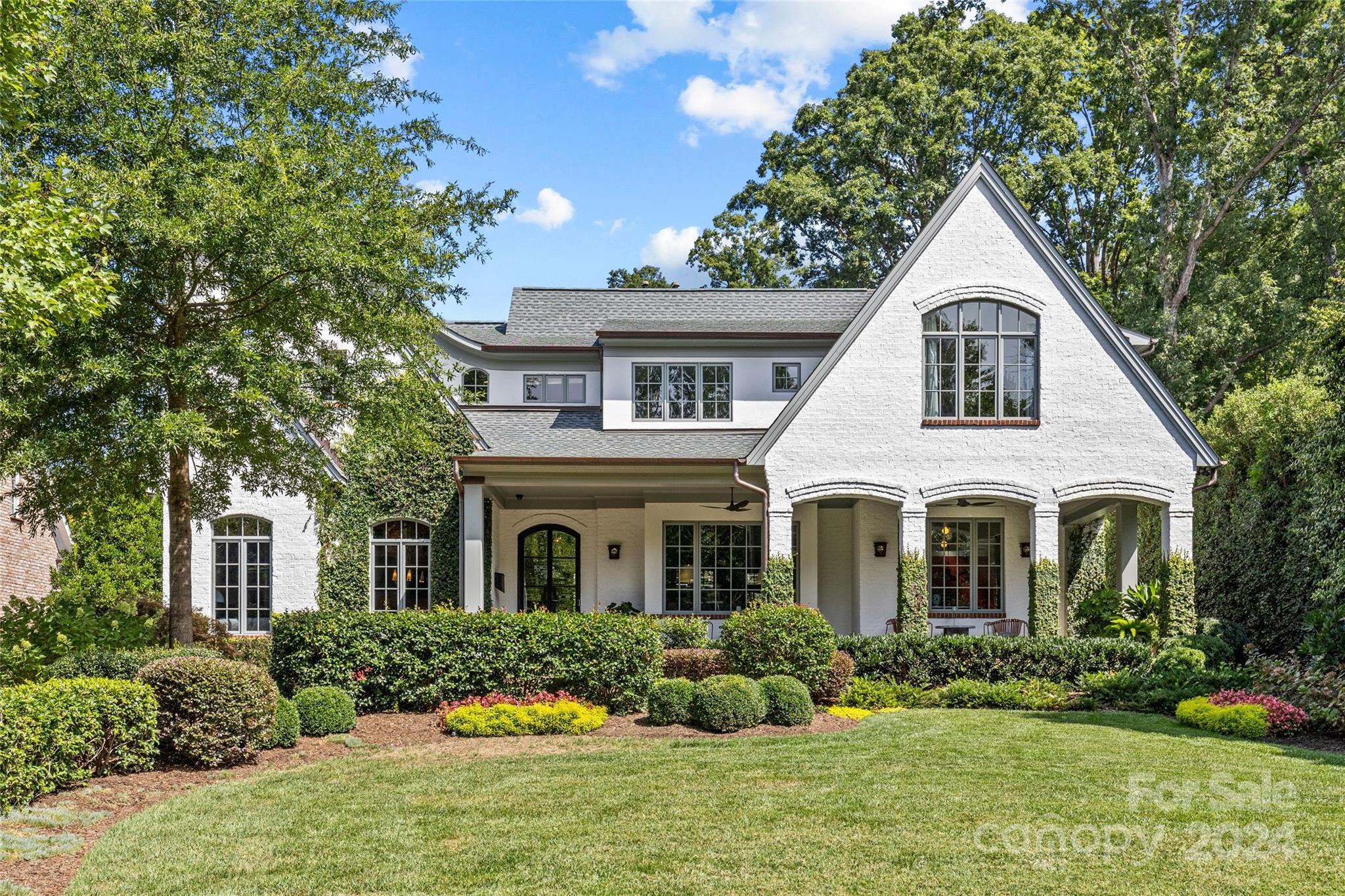 LUXURY LIVING IN EASTOVER! This exceptional home, situated on a great cul-de-sac, features interiors by Barrie Benson and showcases a charming covered front porch with beautiful landscaping. Inside, you will find a stunning sitting room, stylish dining room, and spacious fireside living room that sets the perfect vibe for relaxation. Show-stopping chef's kitchen has lots of natural light, a large island, breakfast room, walk-in pantry, bar and morning bar. The main-level primary suite offers two walk-in closets and an incredible updated spa-like bathroom. Upstairs, enjoy three additional bedrooms, versatile rec. room, cedar closet, laundry room, and a flex office connected to the guest suite. Extend entertaining outdoors on the covered back porch, complete with a fireplace, patio and built-in grill. Expansive private backyard includes sport court. Conveniently located near the shops and restaurants of Eastover and Myers Park, with an easy commute to Uptown, this home truly has it all.
