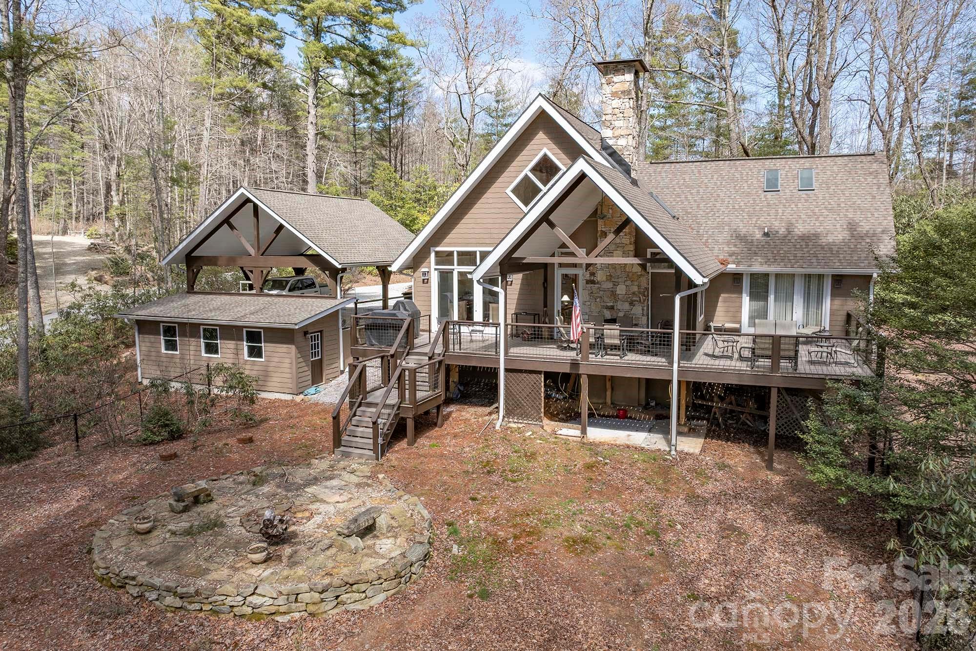 Tucked within the natural beauty of Lake Toxaway Estates, this thoughtfully updated mountain home offers a comfortable blend of modern style and relaxed mountain living. Located just over a mile from the Lake Toxaway Country Club and marina, the property provides both convenience and a peaceful, wooded setting.

The home features 3 bedrooms and 3 baths, along with a versatile bonus room anchored by a cozy fireplace—perfect for additional living space, a media room, or guest overflow. Recent updates to the kitchen and appliances, along with a beautifully renovated primary bath, bring a fresh, mountain-modern feel while maintaining a warm and inviting atmosphere throughout.

Outdoor living is equally appealing, with a fenced yard ideal for pets or play, and a firepit area designed for enjoying cool mountain evenings. A detached two-car carport includes additional workshop space, offering flexibility for storage or hobbies. A whole-home Kohler generator provides added peace of mind year-round.

Offered mostly furnished (with a few exceptions), this home presents a turnkey opportunity to enjoy the Lake Toxaway lifestyle—whether as a full-time residence or a mountain retreat.