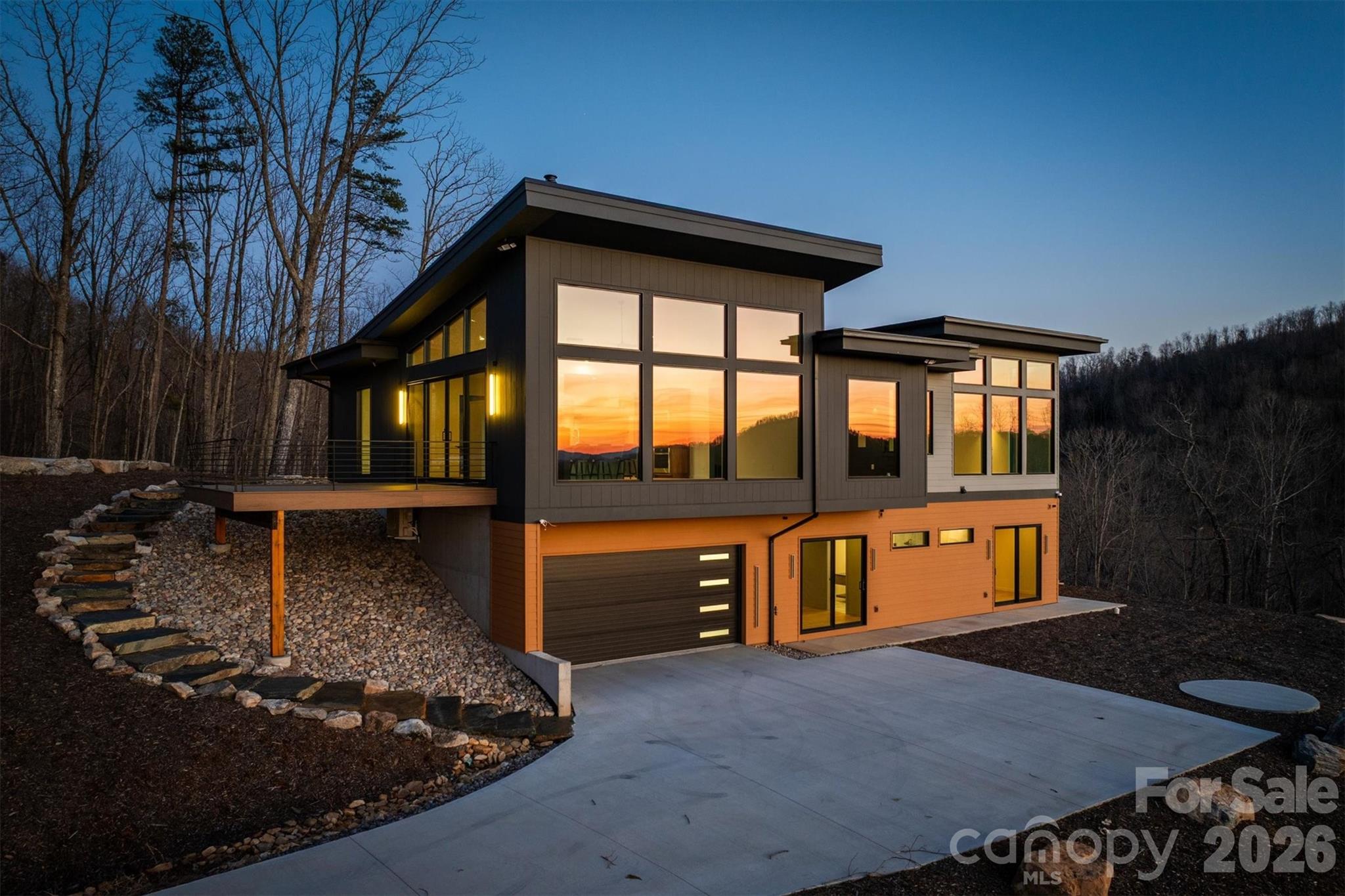 Nestled on 19.89 acres of pristine land, this breathtaking 3-bedroom, 3.5-bathroom mountain modern home offers unparalleled and spectacular multi layered Blue Ridge Mountain and sunset views. Set against a serene wildflower meadow, the property also includes a private walking trail leading to a tranquil creek. Open the front door to a spacious great room with unbelievable mountain views. Large windows invite natural light to flood the space, creating a perfect spot to unwind while watching the sunset paint the sky. The seamless flow between the great room and kitchen allows for easy entertaining, with the chef-inspired kitchen featuring a large island, stainless steel appliances and a glass induction cooktop with restaurant-grade exhaust fan for the serious cook. Off the kitchen you'll find room for an office or theater room offering sound blocking walls and speaker wiring to ensuring a quiet and immersive environment for work or play. The main level also includes a primary suite with breathtaking mountain views, a walk-in closet with built-in closet system and a luxurious en-suite bathroom. Indulge yourself with a zero-entry tiled shower, soaking tub with a mountain vista, double sinks, and heated floors to keep you cozy all year round. The lower level boasts 2 additional bedrooms with en-suite baths, laundry room, exercise room and 2-car heated and cooled garage with plenty of additional space for storage. The home has battery backup with automatic sub-second cutover in case of grid power failure for zero downtime. Equipped with a radon mitigation system, EV charger, and pre-wiring for audio, wifi and cameras throughout the home for the tech savvy buyer. For outdoor living, there is a deck with metal railings and composite decking, lower level patio for a fire pit or hot tub providing ideal spaces for enjoying the fresh mountain air while taking in the stunning views. With its modern design, top-tier finishes, and tech features, this home offers the perfect blend of comfort, convenience, and luxury. Don’t miss out on this rare opportunity to own a piece of this private mountain paradise.