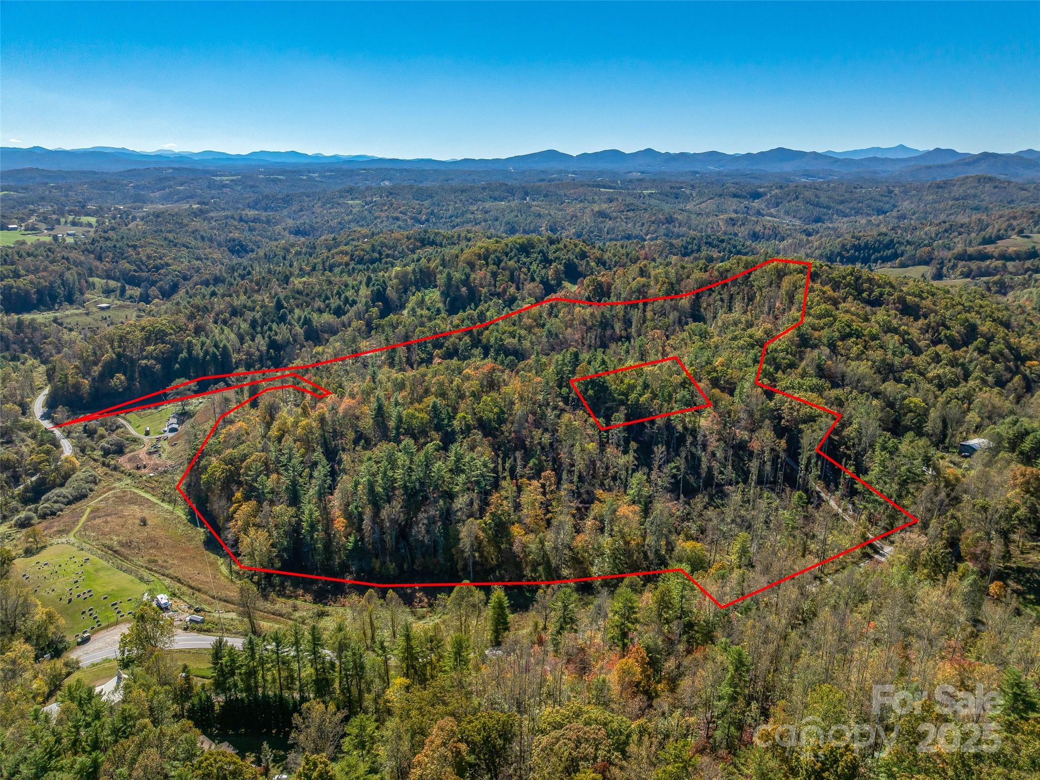 Welcome to 99999 Meadows Town Road in beautiful Marshall, North Carolina — a rare opportunity to own approximately 34 acres of stunning, buildable mountain land just minutes from downtown Marshall and within easy reach of Weaverville and Asheville. This property truly has it all: privacy, convenience, breathtaking long-range mountain view potential, multiple possible home sites, and the infrastructure to make your dream project a reality.
As you arrive, you’ll immediately appreciate the land’s gentle approach and the well-maintained road system that winds gracefully through the property, offering easy access to several prime build sites. Whether your vision is a private mountain estate, a multi-home family retreat, or a small residential development, this property offers a flexible and well-laid-out landscape to accommodate it all. The topography varies beautifully — from rolling meadows and open knolls to wooded ridgelines and shaded valleys — giving you endless possibilities for orientation, layout, and design.
Several locations on the property present opportunities for panoramic, long-range mountain views that stretch across Madison County and beyond. With selective clearing, you could create spectacular building sites that showcase the ever-changing colors of the Blue Ridge Mountains — stunning sunrises, glowing sunsets, and a tapestry of seasonal beauty that makes this region so special. Imagine relaxing on your future porch, overlooking the distant peaks while surrounded by the peace and privacy of your own mountain haven.
In addition to the acreage and build potential, the property includes a 3-stall garage/carport structure — perfect for immediate storage of vehicles, equipment, or recreational gear while you plan your build. This feature adds convenience and value for those looking to establish a workshop, hobby space, or temporary base during construction. The existing access roads throughout the property make exploration and development simple, connecting multiple potential building envelopes while preserving the site’s natural contours and privacy.
The combination of open land and wooded areas creates an ideal environment for those who appreciate both usability and natural beauty. There’s ample space for gardening, small-scale farming, or pasture, while mature trees provide shade, habitat, and a true sense of seclusion. With approximately 34 acres to work with, you can thoughtfully design a property that suits your lifestyle — whether that’s a mountain getaway, equestrian retreat, or collection of cabins for short-term rental opportunities.
Location is key, and this one strikes the perfect balance between rural tranquility and modern convenience. The property sits just a short drive to downtown Marshall, where you’ll find charming shops, cafés, and the scenic French Broad River. A quick 20-minute trip brings you to Weaverville’s restaurants and amenities, and Asheville is only about 30 minutes away — offering vibrant arts, dining, and entertainment options. You’ll enjoy easy access to everything Western North Carolina has to offer while coming home to your own private escape at the end of the day.
Whether you’re seeking an investment opportunity, planning your dream homestead, or simply looking for a peaceful place to put down roots, 99999 Meadows Town Road delivers exceptional potential in a truly beautiful setting. With its combination of long-range mountain view possibilities, existing infrastructure, versatile build sites, and proximity to some of the region’s most desirable mountain towns, this property represents one of the best opportunities currently available in Madison County.
Don’t miss your chance to own a piece of Western North Carolina’s mountain magic — 34 acres of endless possibility, ready for your vision.