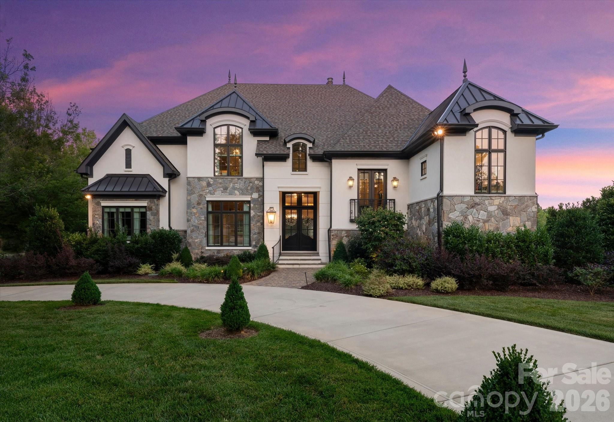 Beautiful luxury New Traditions 2022 home in popular Skyecroft community featuring 7 bedrooms + 6.5 baths and an amazing resort backyard. Home features classic finishes, including all-white oak floors throughout, designer lighting, custom wall moldings, and gorgeous ceiling details. The centerpiece of this home is the beautiful kitchen with ceiling-height cabinetry featuring a stunning mix of soft white and white oak cabinets. Great appliance package includes a commercial 6-burner gas range with double ovens, commercial hood, pot-filler faucet, built-in fridge with white oak panels + a separate microwave and wine fridge. The kitchen also features a full-size scullery with an additional stainless-steel fridge, dishwasher, prep sink, and additional storage cabinets. Lovely great room features a beautiful fireplace with custom white oak built-ins, a coffered ceiling, plus luxurious collapsing glass doors that turn the covered screened terrace into the main living area. Unique floor plan features 2 guest suites on main, half level up primary suite featuring luxury bath, oversized walk-in closet with well-designed custom cabinets + dedicated washer and dryer. Up one level, you will find 4 additional secondary rooms: 2 with a dedicated full bath and 2 with an oversized shared jack-and-jill bath. The second floor also includes a large bonus room/bunk room. The lower level of this amazing home includes a large rec room with bar plus a dedicated exercise room. The lower level also features a full cabana bath with an additional washer/dryer. Lower level opens directly to the pool patio. Outside, take in the great North Carolina weather on the beautiful covered screened terrace with gas fireplace. or relax in front of the built in linear contemporary gas fire pit. Lovely salt water pool is heated and includes a separate hot tub + fire bowls. Don't miss the in-ground trampoline. Home features an oversized 3-car garage, an expanded parking pad, and a circular driveway. Home backs to community pond.  Zoned for A+ Weddington Schools!