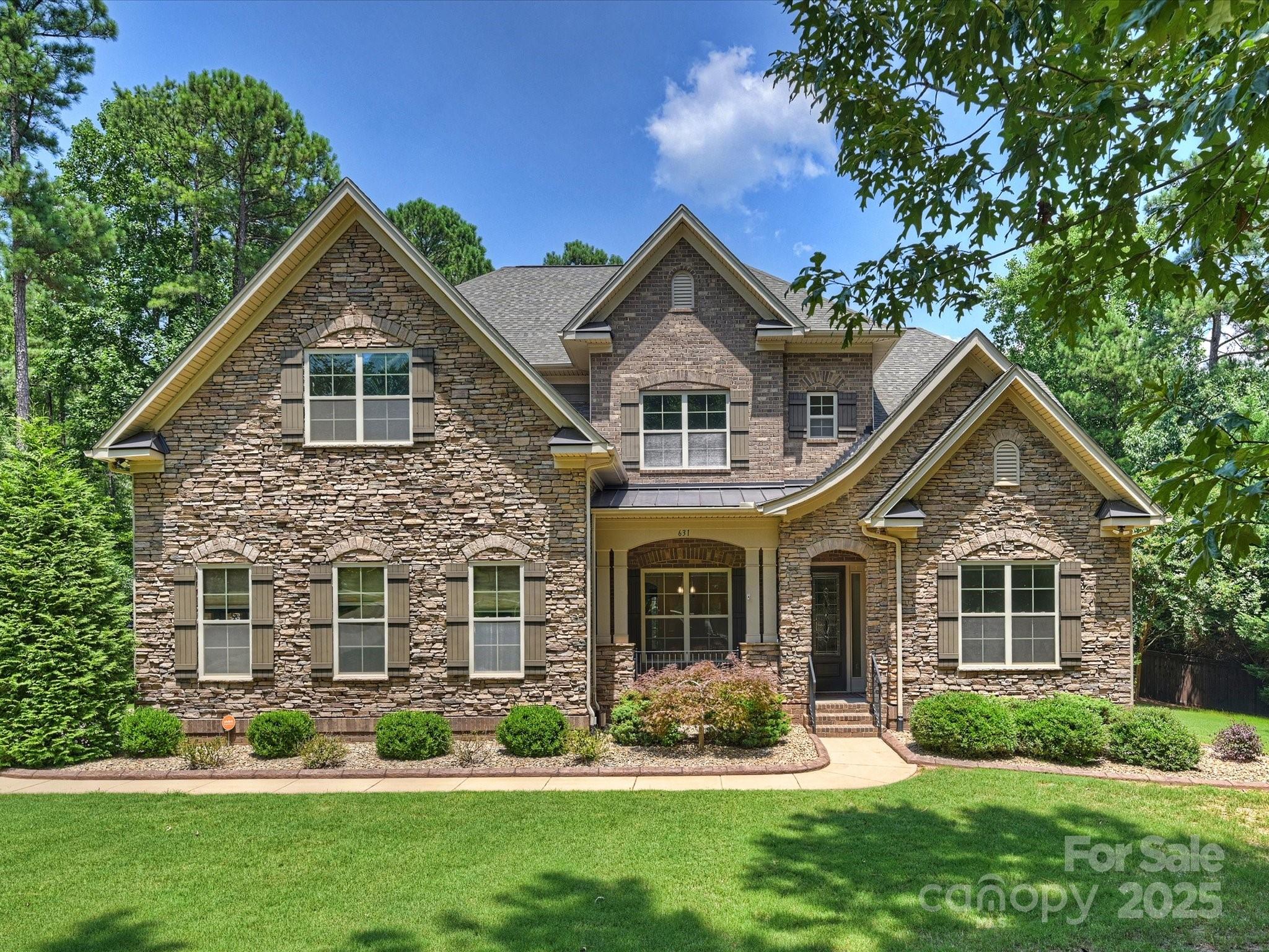Beautiful home w/wonderful floor plan on 2+acre lot featuring private backyard oasis near Lake Wylie! Primary suites on main AND upper levels are generously sized with large bathrooms and huge closets. Open to the great room,the kitchen is a chef's delight boasting ample white cabinets,gorgeous granite countertops,double ovens,gas cooktop,Bosch dishwasher,island and peninsula. Butler's pantry adjoins dining room.Owners converted laundry room off kitchen to huge walk-in pantry w/wood shelving and added a drop zone. Enjoy hours of entertainment in the heated PebbleTec pool with spa surrounded by travertine decking and grill with gas line, then enjoy dinner on the screened porch.Great storage space in oversized 2 car garage with epoxy flooring and detached garage added by owners.Storage racks and cabinets convey.No details were missed-water filtration and softener,tankless water heater,encapsulated crawl space with dehumidifier, and smart Vivint security system with cameras. Welcome home!