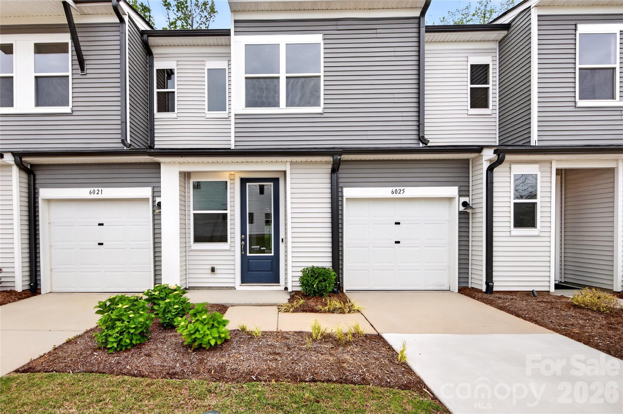 Discover this Conrad plan at 6025 Longar Lane,  a beautifully appointed 3-bedroom, 2.5-bathroom home nestled in Fifteen 15 Cannon, our urban oasis in the heart of Charlotte, NC, where soaring ceilings, low-maintenance living, and tree-lined surroundings create an elevated everyday experience. The open-concept first floor is made for modern living, anchored by a chef-inspired kitchen that pairs rich brown cabinetry with dramatic Black Pearl Leathered countertops, a large single-bowl stainless steel sink with an Essa kitchen faucet, and a Modern Hearth 3x12 White Ash backsplash,  a bold, design-forward combination that feels right at home. A convenient powder room and a thoughtfully tucked pet area under the stairs round out the main level, while upstairs the primary suite delivers the retreat feel you expect, featuring a dual-vanity bath and a walk-in shower. Situated in the same building as the community's model homes and backing up to mature trees, this home offers a rare sense of privacy in its outdoor living space, an uncommon find in urban neighborhoods. Step outside the front door and you're moments from Charlotte's best dining, arts, and entertainment, with tree-lined walking paths and cared-for landscaping handled for you, so you can spend less time on upkeep and more time enjoying everything the city has to offer.