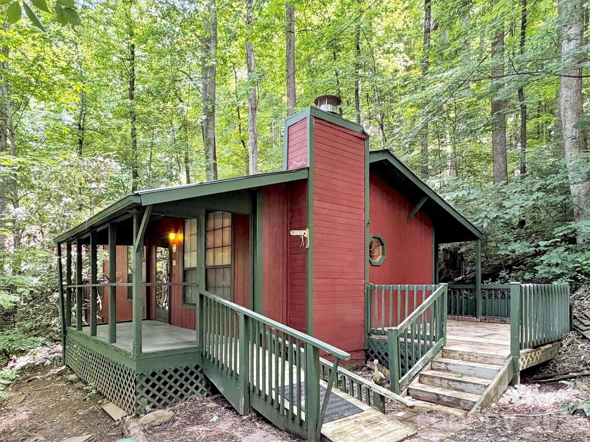 Welcome to 279 Rocky Top Road, where mountain charm meets convenience in the heart of Maggie Valley. Nestled on approximately 1.2 wooded acres, this inviting cabin offers a peaceful mountain setting just minutes from the shops, restaurants, festivals, and outdoor adventures that make Maggie Valley such a sought-after destination.

*Important Heated Square Footage Information:* The heated square footage reported in the MLS is approximately 440 square feet and is reflected in accordance with current MLS measurement guidelines. The cabin offers approximately 640 square feet of finished interior space, including two bedrooms and one bathroom. According to the seller, the professionally installed mini split has comfortably heated and cooled 550 square feet, allowing buyers to enjoy all of the home's finished living areas while providing clear and transparent reporting of the heated square footage.

Inside, warm wood finishes, abundant natural light, and an open living, dining, and kitchen area create a welcoming atmosphere that feels comfortable, functional, and larger than its footprint. The thoughtfully designed floor plan makes excellent use of every square foot, providing inviting gathering spaces along with two comfortable bedrooms and a full bath.

Enjoy your morning coffee surrounded by the peaceful sights and sounds of the Smoky Mountains, then spend the day exploring nearby attractions including the Blue Ridge Parkway, Great Smoky Mountains National Park, Cataloochee Ski Area, hiking trails, fishing, golf, local boutiques, and favorite Maggie Valley restaurants. Whether you're seeking outdoor adventure or a relaxing mountain escape, everything is just minutes away.

Whether you're searching for a low maintenance primary residence, a weekend retreat, or an investment property, this charming mountain cabin offers comfort, character, and an unbeatable Maggie Valley location with easy access to everything Western North Carolina has to offer.
