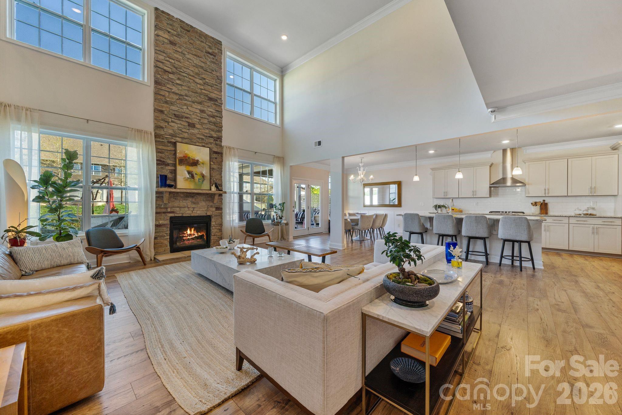Welcome to 2111 Lapalma Trace, a home that truly stands out for its layout, space, and everyday livability. From the moment you enter, the floor plan just makes sense, with a natural flow that feels both open and functional. The main level offers a spacious primary suite and a dedicated office, while the two story great room is filled with natural light and centered around a gas fireplace, creating a warm and inviting space that connects seamlessly to the rest of the home. The kitchen is the heart of it all, featuring granite countertops, a gas cooktop with hood, double ovens, an oversized island, walk in pantry, and a reverse osmosis filtration system at the sink.
Upstairs, you will find four additional bedrooms, three full bathrooms, a large loft space perfect for a media or bonus room, a laundry room, and a separate oversized storage closet, offering flexibility and room to grow. Additional interior upgrades include a whole house water filtration system, adding another layer of comfort and convenience.

The outdoor living space has been thoughtfully upgraded to create a true extension of the home, with a custom back patio, built in fireplace with integrated seating, and a fully equipped outdoor kitchen with built in grill. The fully fenced backyard also features a dedicated vegetable garden with its own irrigation system. Located in the highly sought after Clover school district, the community offers amenities including a clubhouse, pool, playground, picnic area, pickleball courts, and sidewalks, all just minutes from Lake Wylie, shopping, and dining.