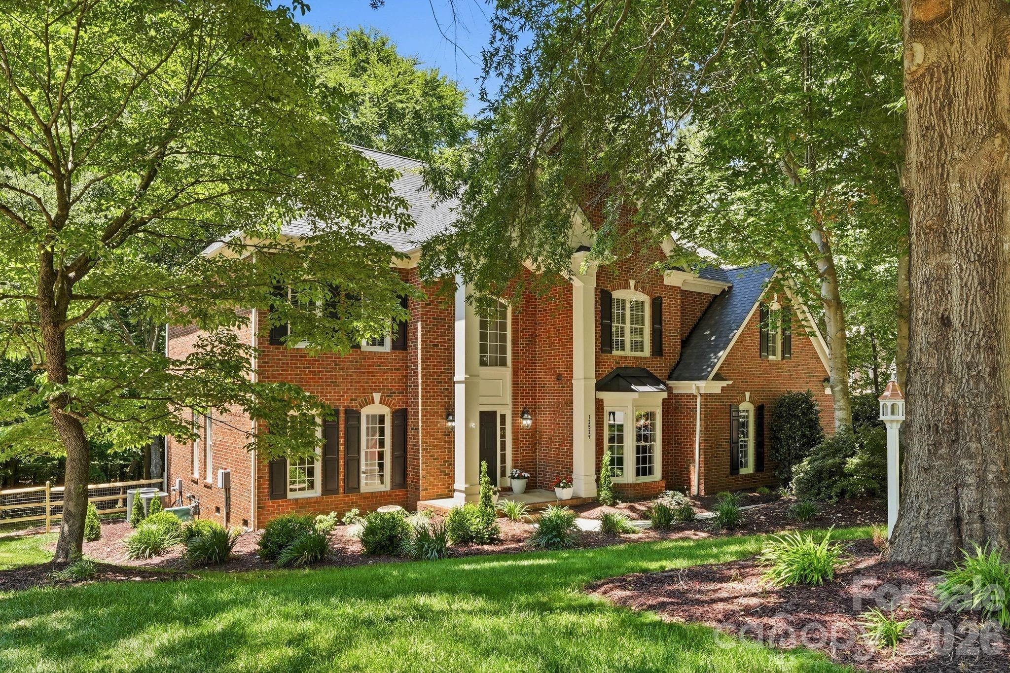 Hidden beneath a breathtaking canopy of mature trees in Charlotte's coveted Overlook community, this Mountain Island home offers the perfect balance of privacy, space, and convenience. This stately full-brick residence features 5 bedrooms, 3.5 bathrooms, and over 3,800 square feet designed for both elegant entertaining and comfortable everyday living. A dedicated home office provides a refined workspace, while the expansive backyard offers endless possibilities for an outdoor living retreat, recreation space, or garden oasis. Just moments from Mountain Island Lake, residents enjoy a lifestyle centered around boating, nature, and outdoor recreation, with convenient access to I-485, Highway 16, Uptown Charlotte, shopping, dining, and everyday essentials. Rarely does a property combine such a private setting, generous homesite, established neighborhood, and prime location all at a price point under $1 million.