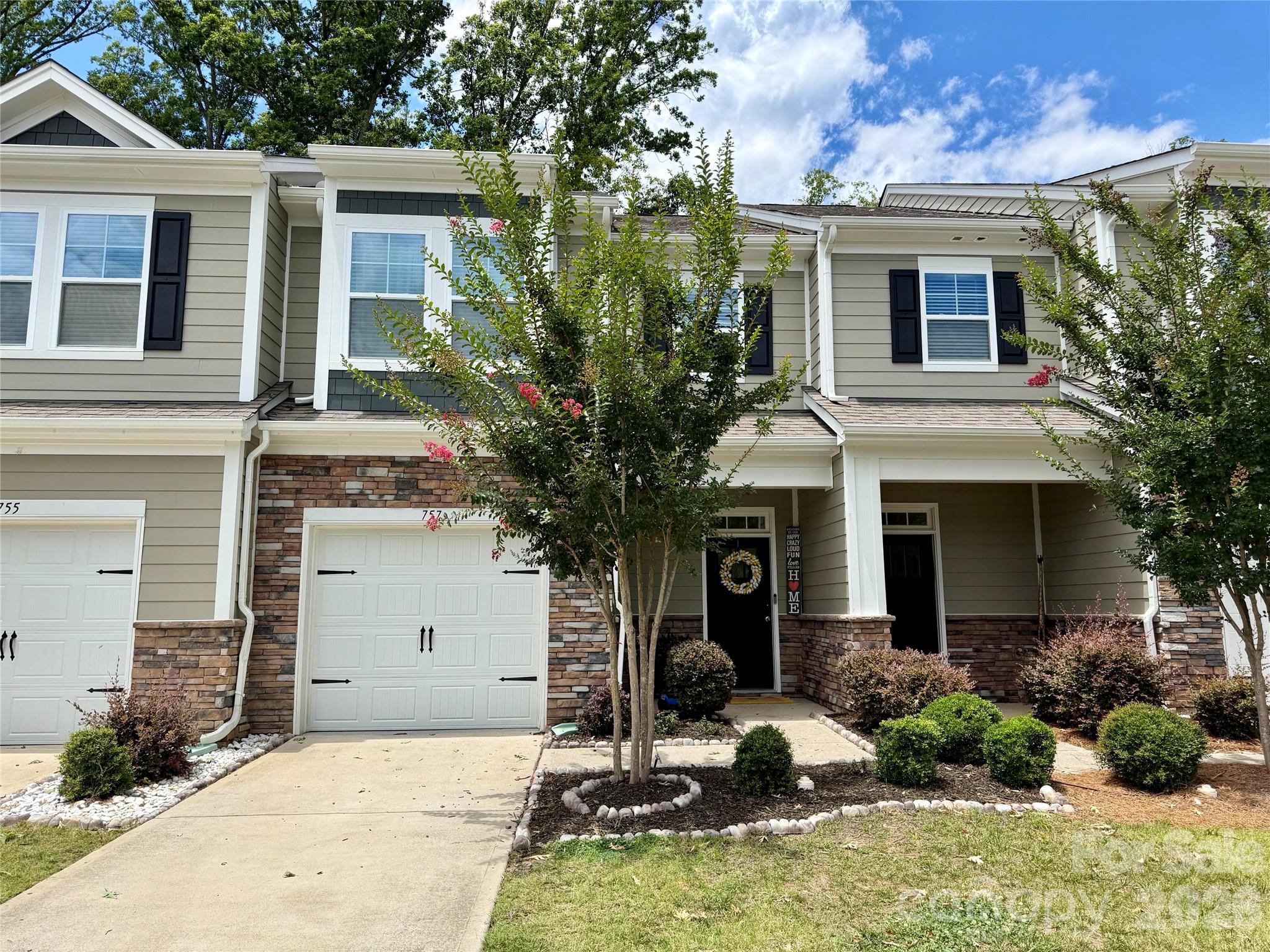 Discover modern elegance and cozy charm in this 3-bedroom, 2.5-bath townhome in Ivy Ridge. On a quiet cul-de-sac, it offers peace in a vibrant neighborhood. Built in 2020 and upgraded, it features style, function, and low-maintenance living.Enter the open-concept main level: custom fireplace in living room with cabinetry and shelving for relaxation or display; dining area with updated light fixture; half bath with new vanity and trendy wallpaper.Upstairs: three bedrooms including spacious primary suite. Contemporary vibe throughout.Community amenities: clubhouse, pool, pickleball court. Easy access to shops, dining, and Clover schools. Gateway to effortless living. Don't miss it!