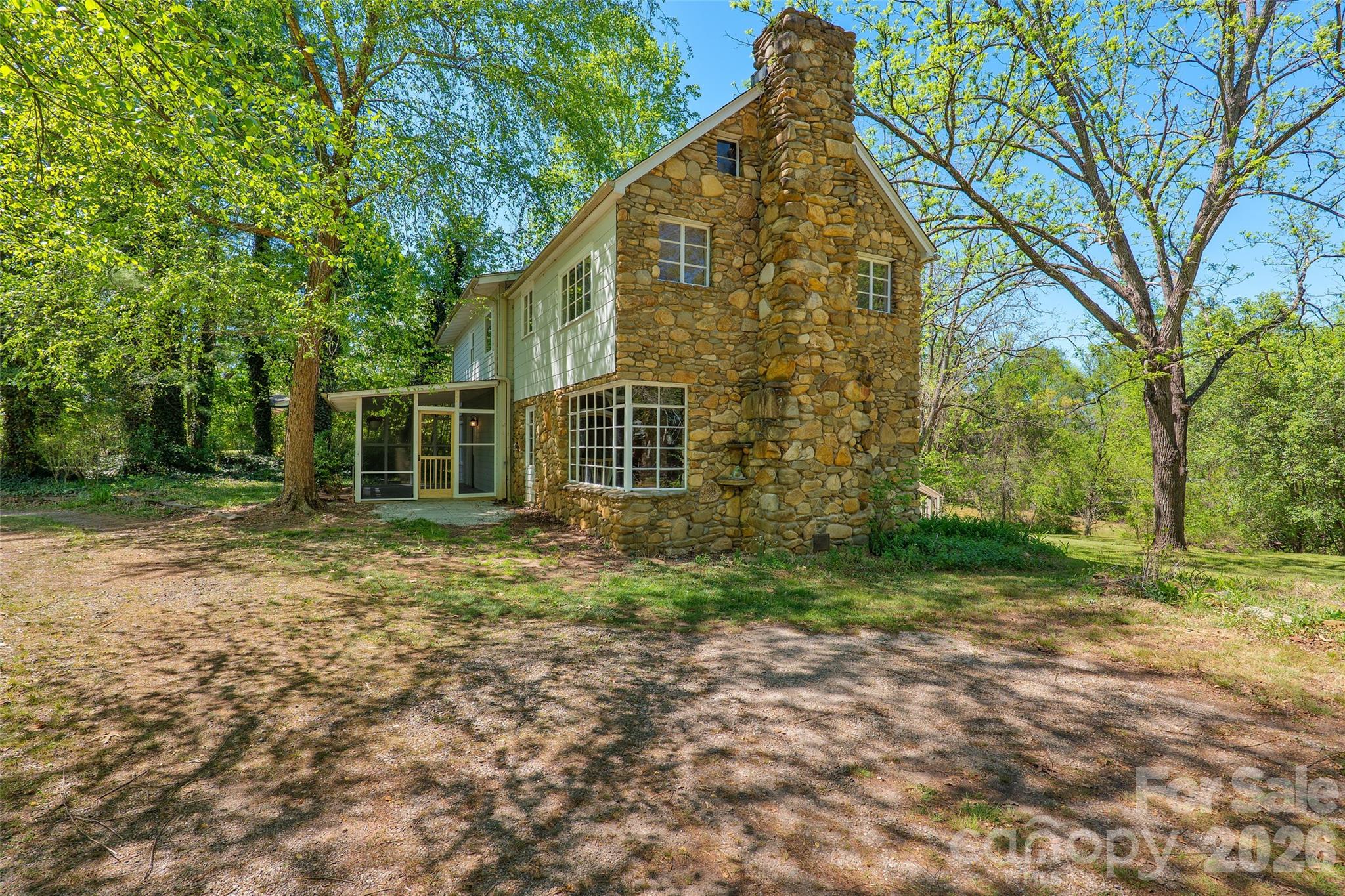 Renovated 3-bedroom farmhouse on a rare 1.48-acre homesite offers historic charm, modern updates and exceptional potential. The brand-new eat-in kitchen opens to a spacious dining room with fireplace, while the inviting living room showcases exposed stone walls, a second fireplace, tongue-and-groove ceiling and authentic character rarely found in newer homes. The main level includes a laundry room, mudroom, and half bath for everyday convenience. Upstairs, three spacious bedrooms feature original woodwork, generous closet space, abundant natural light, a full bath, and easy attic storage. Outside, the parcel offers privacy, usable land and room for gardens, outbuildings, garage or future expansion. Ample parking accommodates multiple vehicles, trailers, RV and equipment. A fusion of vintage character with modern convenience, this move-in-ready farmhouse delivers the space, flexibility, and lifestyle of the mountains only about 15 minutes from all things Asheville!