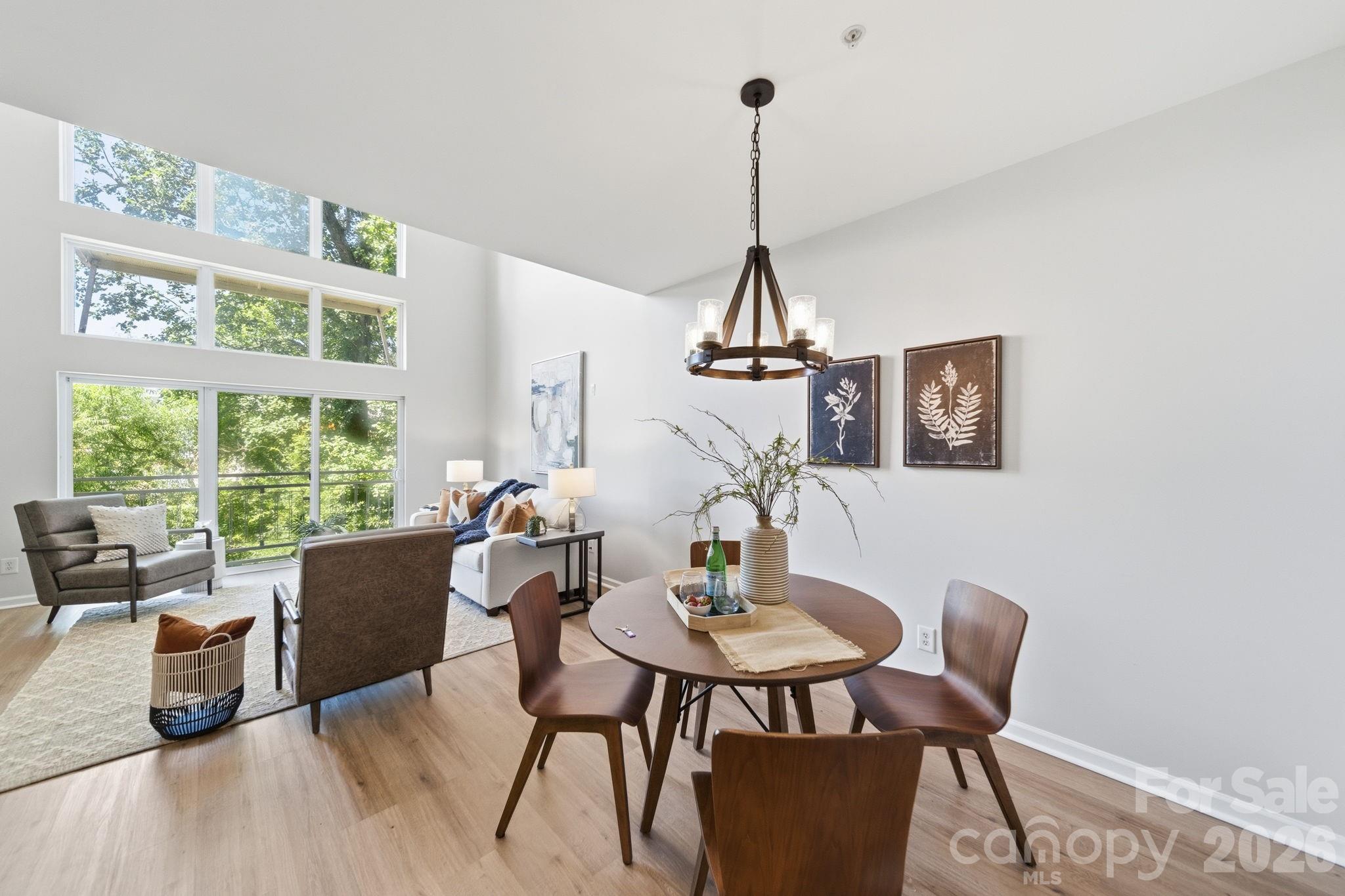 Live in the heart of NoDa at The Renaissance! This move-in-ready 3-bedroom, 2.5-bath condo offers approximately 1,800 square feet, an attached one-car garage, and one of the community's most distinctive features—an expansive private terrace measuring approximately 10' x 20', creating a true outdoor living space rarely found in urban condo living.

Fresh paint, brand-new flooring, soaring two-story ceilings, and large windows create a bright, airy feel throughout. The main level flows easily for everyday living and entertaining, with a kitchen featuring granite countertops, tile backsplash, stainless steel appliances, ample storage, and a seamless connection to the dining and living areas.

The private terrace provides exceptional space for outdoor dining, entertaining, container gardening, or simply relaxing in a tree-lined setting. A Juliet balcony overlooking the community courtyard, pool, and grilling area adds even more charm and natural light.

A spacious loft provides valuable flexibility for a home office, media room, workout area, playroom, or second living space. The primary suite includes a walk-in closet and private bath, while two additional bedrooms offer room for guests, work, or hobbies.

Tucked toward the back of the community with treetop views from both the front and rear windows, this home offers a rare blend of NoDa convenience and peaceful surroundings. Approximately a 10-minute walk to the light rail, with easy access to NoDa's restaurants, breweries, shopping, live music, and entertainment.