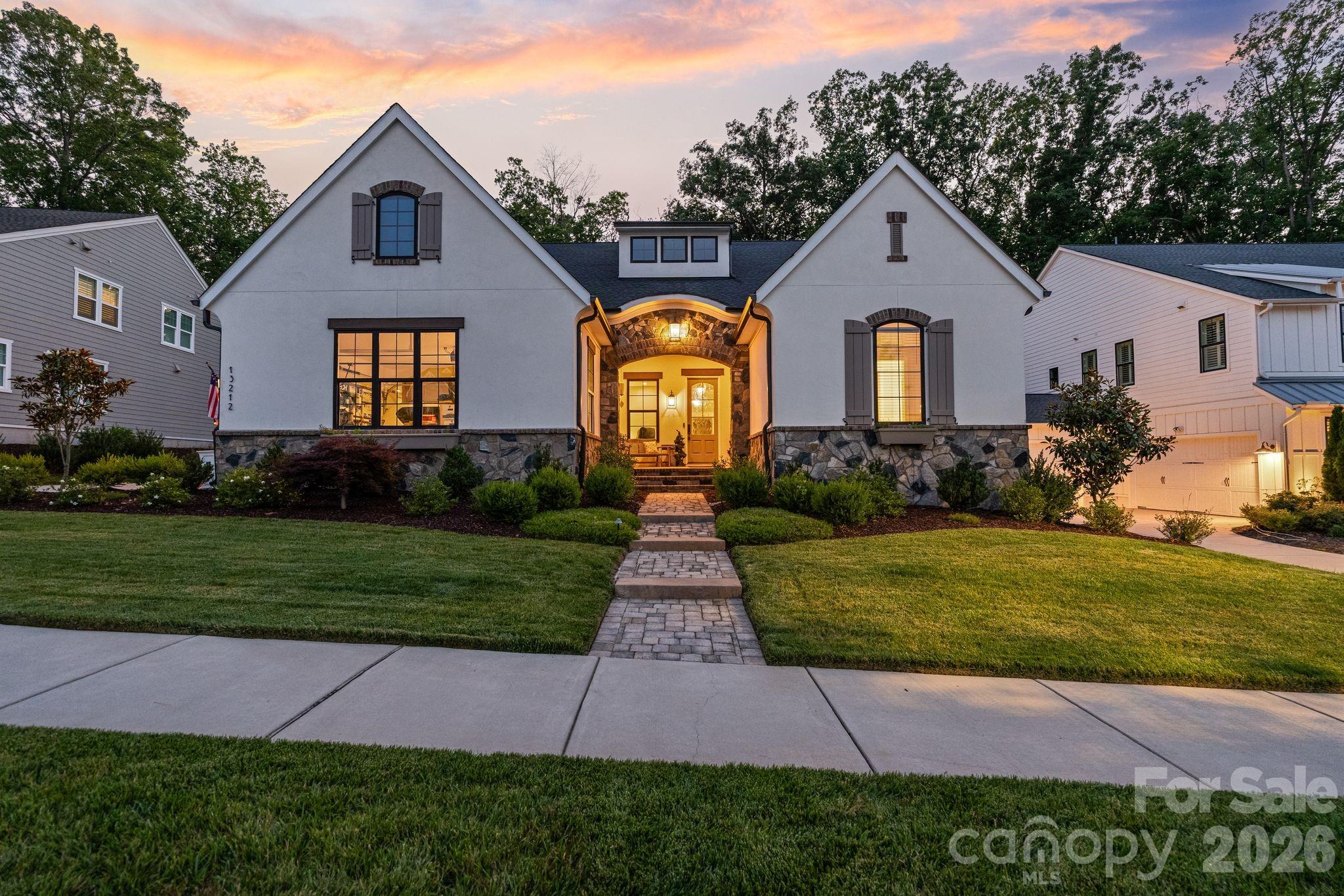 Exceptional Classica-built luxury home in the highly sought-after Oak Farm community. Built in 2022 and thoughtfully enhanced with extensive custom upgrades, this 4-bedroom, 3.5-bath residence offers over 4,300 square feet of beautifully designed living space, blending timeless craftsmanship with modern convenience.

The heart of the home is a stunning chef's kitchen featuring an oversized island, premium KitchenAid appliances, a six-burner gas range, double dishwashers, quartz countertops, a spacious pantry, and a separate scullery complete with additional prep space, sink, and wine refrigerator. Expansive living spaces filled with natural light seamlessly connect to the outdoor living areas through impressive stacking glass doors, creating an effortless indoor-outdoor lifestyle.

The private primary suite offers a true retreat with a cathedral ceiling, custom closet system, direct laundry room access, and a spa-inspired bath highlighted by a spectacular glass-enclosed "jewel box" shower with rainfall and wall-mounted shower features.

Designed for entertaining, the screened porch showcases brick flooring, a stone gas fireplace, and is pre-wired for heaters and speakers. Beyond, enjoy a stamped concrete patio, custom gazebo, professionally designed landscaping, and a private backyard backing to permanent HOA-protected woods. The setting offers exceptional privacy while still being minutes from shopping, dining, I-77, and everyday conveniences.


Additional highlights include extensive custom millwork and architectural wall detailing, custom closet systems throughout, Ethernet wiring, walk-in attic storage, whole-house water filtration, reverse osmosis drinking water system, insulated garage doors, epoxy garage flooring, smart garage technology, and an upstairs bonus/media retreat featuring a custom built-in bar pre-plumbed for a future sink.

Oak Farm offers a vibrant community atmosphere with gathering spaces, green space, fire pit, and neighborhood events, creating a rare combination of luxury, privacy, and connection.