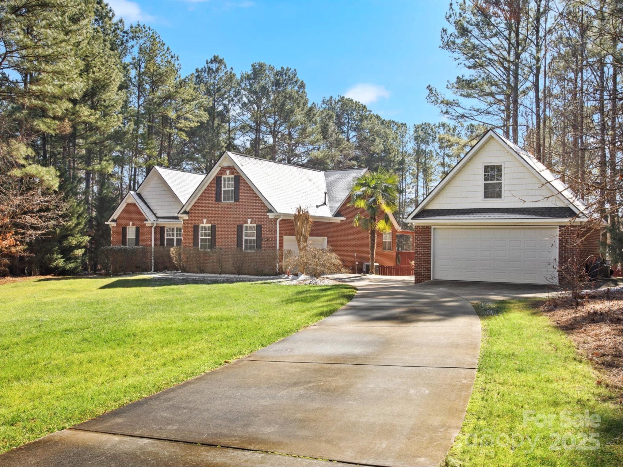 Stunning 3-Bedroom, 2-Bathroom Home on 1+ Acre with Bonus Room and Expansive Pond Views. Nestled on over 1 acre of picturesque land, this charming 3-bedroom, 2-bathroom home offers a peaceful vacation getaway feel with ample space both inside and out. The oversized primary bedroom on the main floor is a true king-sized retreat with beautiful views of the backyard just outside the window. The secondary bedrooms are tucked in towards the front of the house and share a hall bath. The dining room is ideal for entertaining and leads right into the kitchen and the perfect for your kitchen table. The bonus room is ready for game day and when you're ready to head outside, enjoy the back deck, sit by the firepit or stroll on the dock of the pond. 
The attached garage has extra storage and the detached garage is perfect for your golf cart, boat or extra storage needs. Low HOA fees and close to shopping, it's the perfect blend of city and country in one house. Come see it today!
