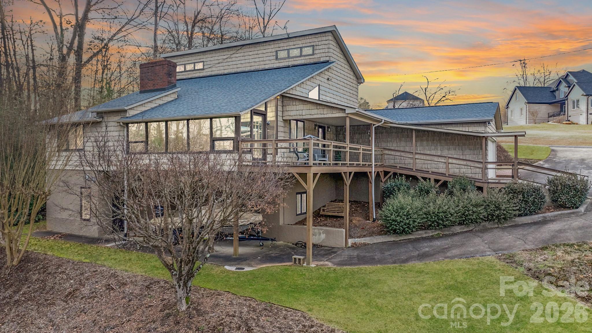 Third and Forth sleeping areas are available in this Peaceful & Serene Lakefront Retreat. Experience the tranquility of private cove living. Relax on sheltered patios, porches, or the year-round sunroom with access to a wraparound deck. The main floor offers primary BR with a walk through full bath to the kitchen, dbl. closets. Main level laundry. The open-concept living area features carpet and hardwood floors, a cozy gas log fireplace, and a charming loft above. The bsmt. offers another living space w/ a full kitchen, full ba., laundry plus access to outdoor spaces—perfect for guests, multi-generational families or ABNB. Enjoy the summers on your Dbl-deck boat slip w/ an additional enclosed boat garage. Dbl garage and single carport with a gravel pull off area perfect for multi parking spaces, a boat trailer or those lake toys. Furniture is negotiable. Must-see to truly appreciate its charm, functionality and income opportunity
