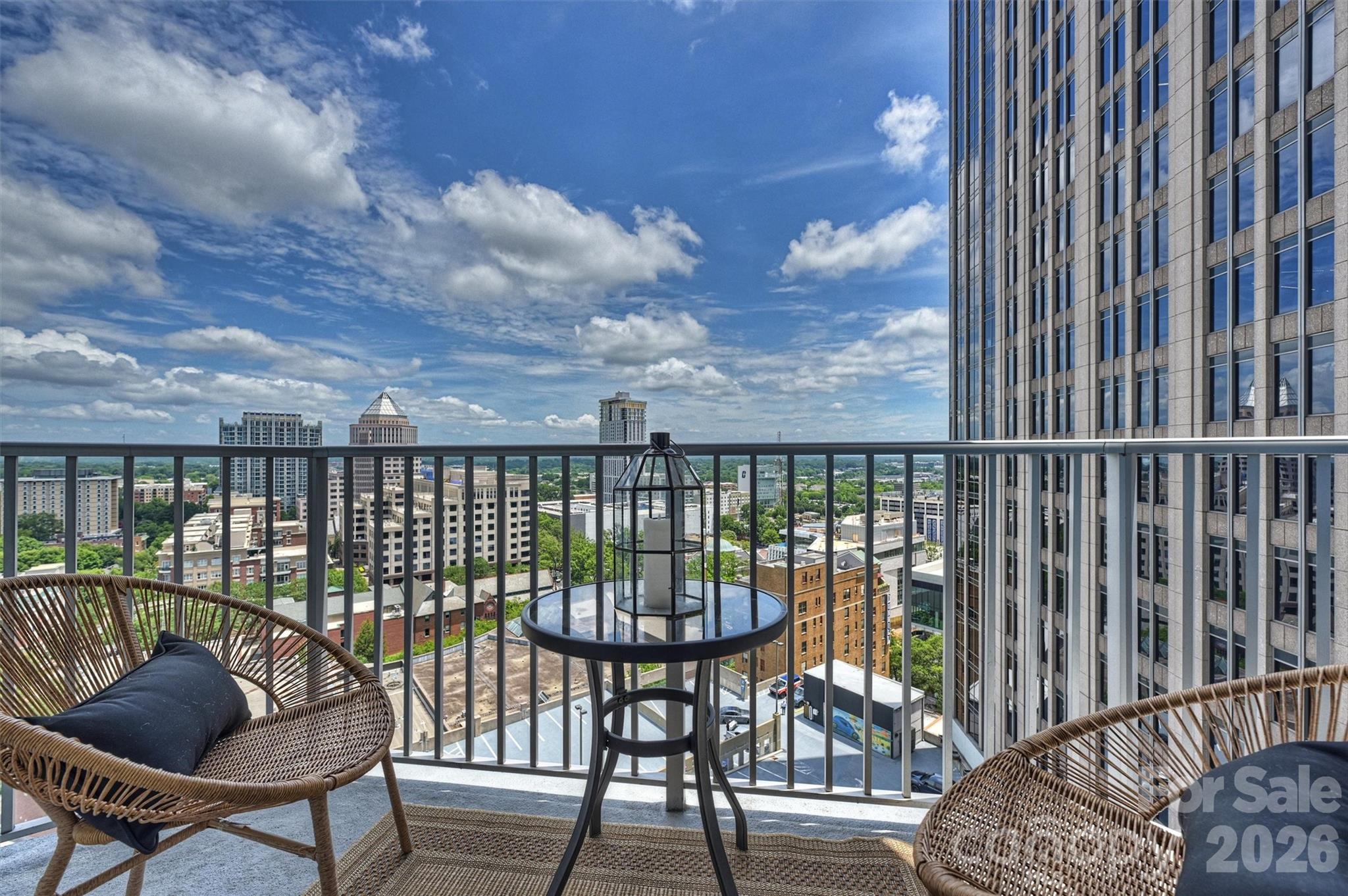Welcome to 210 N. Church Street #1711 at The Avenue, one of Uptown Charlotte's premier luxury high-rise communities. Perched on the 17th floor, this beautifully appointed one-bedroom, one-bath residence offers spectacular panoramic skyline views and an exceptional urban lifestyle. Designed with both style and functionality in mind, the open-concept floor plan features soaring ceilings, expansive floor-to-ceiling windows, and breathtaking unobstructed views that stretch for miles. Abundant natural morning light fills the home, creating a bright, sophisticated atmosphere ideal for everyday living or a luxurious part-time city retreat. Step onto the expansive private balcony to enjoy evening cocktails (facing east so no harsh afternoon sun) or morning coffee with spectacular sunrise views over the Charlotte skyline. The well-appointed kitchen is both elegant and functional, featuring granite countertops, rich wood cabinetry, a tile backsplash, breakfast bar, and pantry. Additional highlights include beautiful wood flooring, recessed lighting, and a dedicated work-from-home nook that offers the perfect space for remote work or study. The residence also includes a deeded parking space conveniently located on the 6th floor adjacent to the elevator. The Avenue offers an outstanding collection of resort-style amenities, including a rooftop saltwater pool with sweeping skyline views, an outdoor fireplace and grilling terrace, the Sky Lounge with billiards and entertaining space, a 24-hour fitness center, business center, secure key-fob access, Amazon package lockers, and 24-hour concierge service. HOA dues include water, sewer, trash, Google Fiber internet, and access to all community amenities. Ideally situated in the heart of Uptown Charlotte, you are minutes to Romare Bearden Park, Truist Field, Bank of America Stadium, Spectrum Center, Blumenthal Performing Arts Center, Discovery Place, Monarch Market, Harris Teeter, the LYNX Light Rail, award-winning restaurants, vibrant nightlife, and Charlotte's premier sports and entertainment venues. Experience elevated city living with luxury amenities, unmatched convenience, and breathtaking skyline views—all from one of Uptown Charlotte's most sought-after addresses.