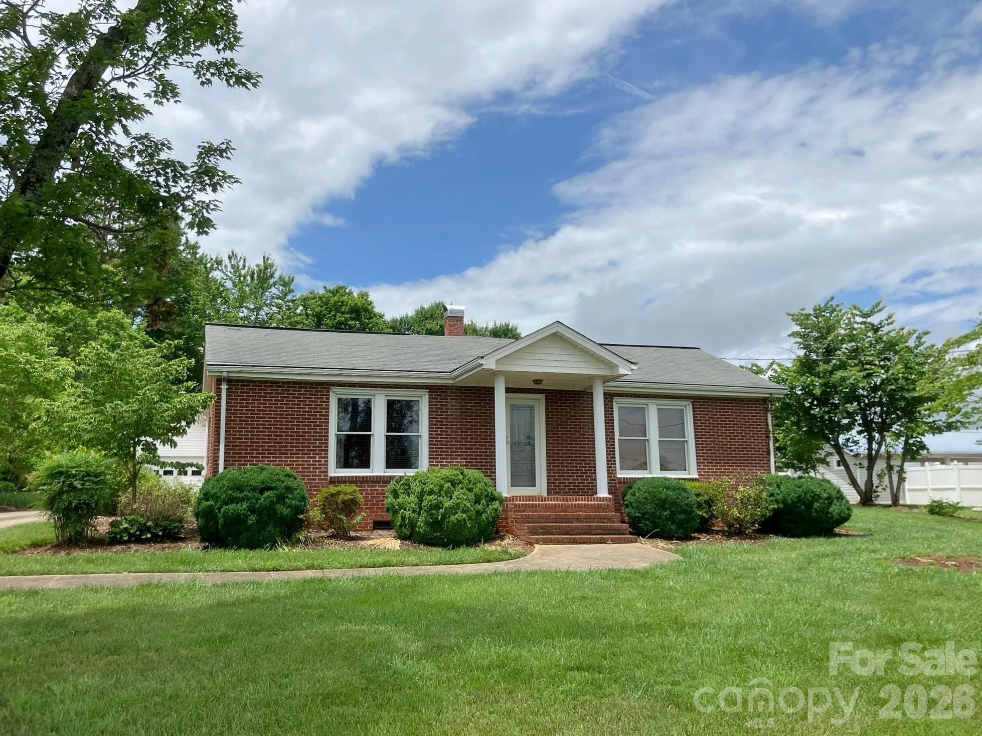 Step back into a simpler time in this charming 3BR/2BA mid-century home offering 1,485 SF nestled in a lovely rural setting just outside Rutherfordton. Enjoy the peaceful surroundings while remaining conveniently close to shopping, restaurants, and medical facilities—all with public water and no city taxes. Inside, the home offers a warm, inviting feel with beautiful knotty pine tongue-and-groove walls and ceilings that create cozy character throughout, complemented by hardwood flooring that adds to the home’s timeless appeal. In addition to the living room, the den features a ventless gas fireplace that adds warmth and comfort—creating an inviting space to relax and unwind. Adjoining the primary bedroom is a versatile bonus room—ideal for a home office, craft space, study, nursery, or other flexible use. Two rooms currently used as bedrooms do not include closets. An enclosed back porch serves as the laundry area and adds practical everyday functionality.

 Outside, enjoy approximately 1 acre with a spacious backyard featuring beautiful mountain views. Additional features include a detached single car garage with storage plus a separate storage building for hobbies, tools, or extra space. Washer/dryer are negotiable. Septic permit on file for 4 bedrooms. Well maintained and ready for its next chapter, this home has been lovingly cared for and is ready for a new owner to make it their own. A rare opportunity to enjoy country charm with everyday convenience.