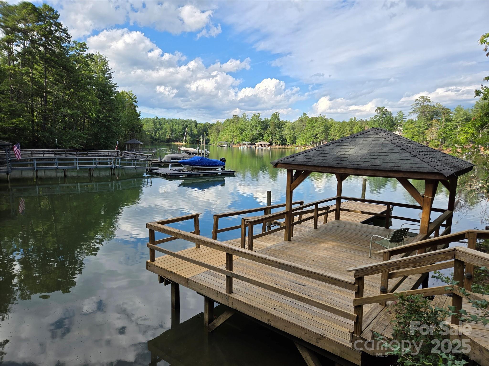 Located in the premier Southpointe Community of Lake James & nestled within the serene sought after Sherman’s Cove, this strategically placed (on 2.21 acres) & completely remodeled lakefront home is a work of art. You’ll love entertaining with the open floor concept or out on the large private deck overlooking the lake. Next, follow the wooden boardwalk from your spacious backyard to your private boat dock and gazebo. The kitchen boasts custom cabinets, granite countertops, a large island, & brand new appliances. The unique master bath offers a large dressing/closet area, double sinks, & a walk-in tile shower. An unfinished basement with roughed-in plumbing provides additional space & has unlimited potential. Located between Asheville & Hickory, a scenic 10-mile drive places you on I-40, or in Historic Downtown Morganton where you’ll find an array of restaurants, professional services, parks & entertainment. This stunning 4-bedroom (2 on main floor), 3.5 bath lakefront home is the one. In addition, all flooring on the main level (White Oak Select and Tile) is brand new as well as the plumbing, electric, appliances, custom cabinets, granite, sinks, commodes, tankless water heater, most doors (including garage doors), and windows (Quaker and Therma-Tru).  The oven is electric with a gas top plus there is an underground propane tank (1,000 gallons) which is owned by the seller.