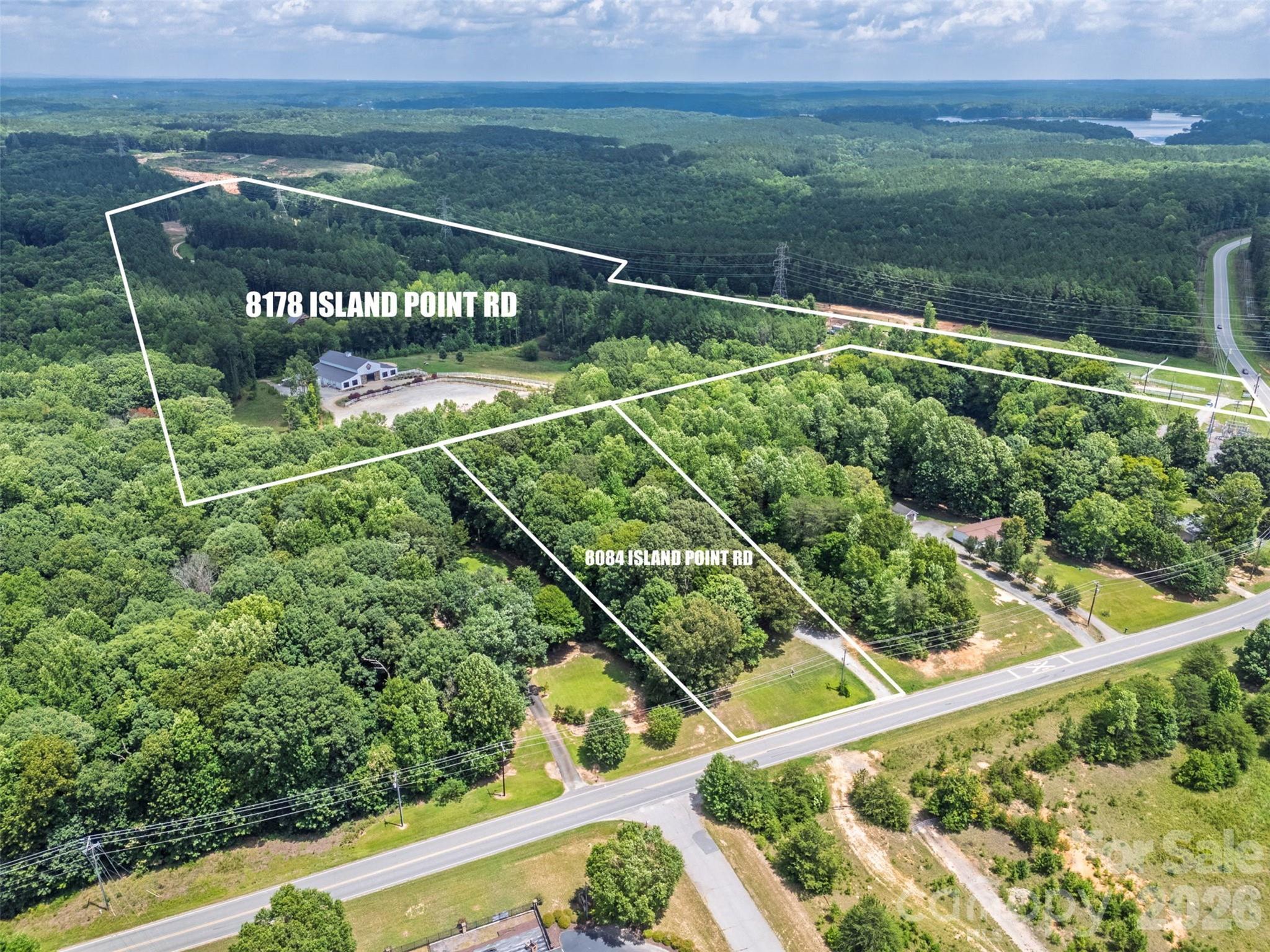 Rare 66.55± acre land assemblage in booming Sherrills Ford, minutes from Lake Norman! This exceptional offering combines 8178 & 8084 Island Point Rd into one contiguous tract, giving a builder or developer a sizable, scarce land position in one of the fastest-growing lake markets in the Charlotte region.

Nearly 67 contiguous acres of this scale is increasingly difficult to assemble in this submarket, making it a compelling candidate for a single-family subdivision, estate lot community, cluster/conservation-style development preserving open space, or a phased master-planned community, subject to county approval. The property sits just 8 miles from Denver, 12 miles from Mooresville, and roughly 36 miles from Charlotte, offering the scale and privacy of a large acreage parcel while remaining within easy reach of established Lake Norman towns and the greater Charlotte metro.

Sherrills Ford has experienced sustained residential growth, driven by relocation into the Charlotte metro and continued demand for lake-adjacent living, positioning this land for strong long-term value. An existing 14,000 SF structure sits on the property and may be incorporated, adapted, or removed as part of a future residential plan. Buyers are encouraged to independently confirm zoning classification, allowable density, required setbacks, floodplain and environmental constraints, and utility extension requirements with Catawba County prior to submitting an offer contingent on development feasibility.

Offered at $3,327,500 ($50,000/acre), fee simple, with no lease or tenant encumbrances. Property sold as-is. Buyer to perform independent due diligence on all zoning, land-use, engineering, and environmental matters. Don't miss this rare opportunity to secure a large, contiguous land position in one of Lake Norman's most sought after growth corridors!