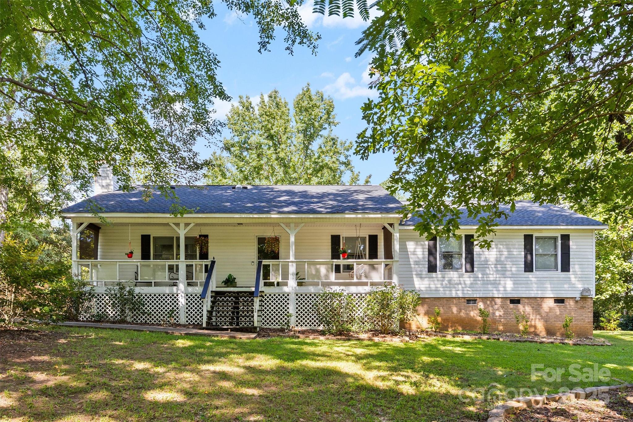 Situated on a spacious ¾-acre lot in the quiet Ridgewood Farms community, this charming ranch offers the perfect blend of comfort and convenience with no HOA. The home features three bedrooms and two full baths, along with a welcoming rocking chair front porch that sets the tone for relaxed living. A large sunroom, complete with its own Amana system for heating and cooling, provides additional living space to enjoy year-round. Outside, you’ll find three covered carport spaces (two paved), a back deck partially sheltered by the carport roof for entertaining, and a sizable shed offered as-is for extra storage. Located in the award-winning Clover School District, this property combines a peaceful neighborhood setting with easy access to Lake Wylie’s shopping, dining, and recreation. With larger lots and a friendly community feel, Ridgewood Farms is an ideal place to call home.