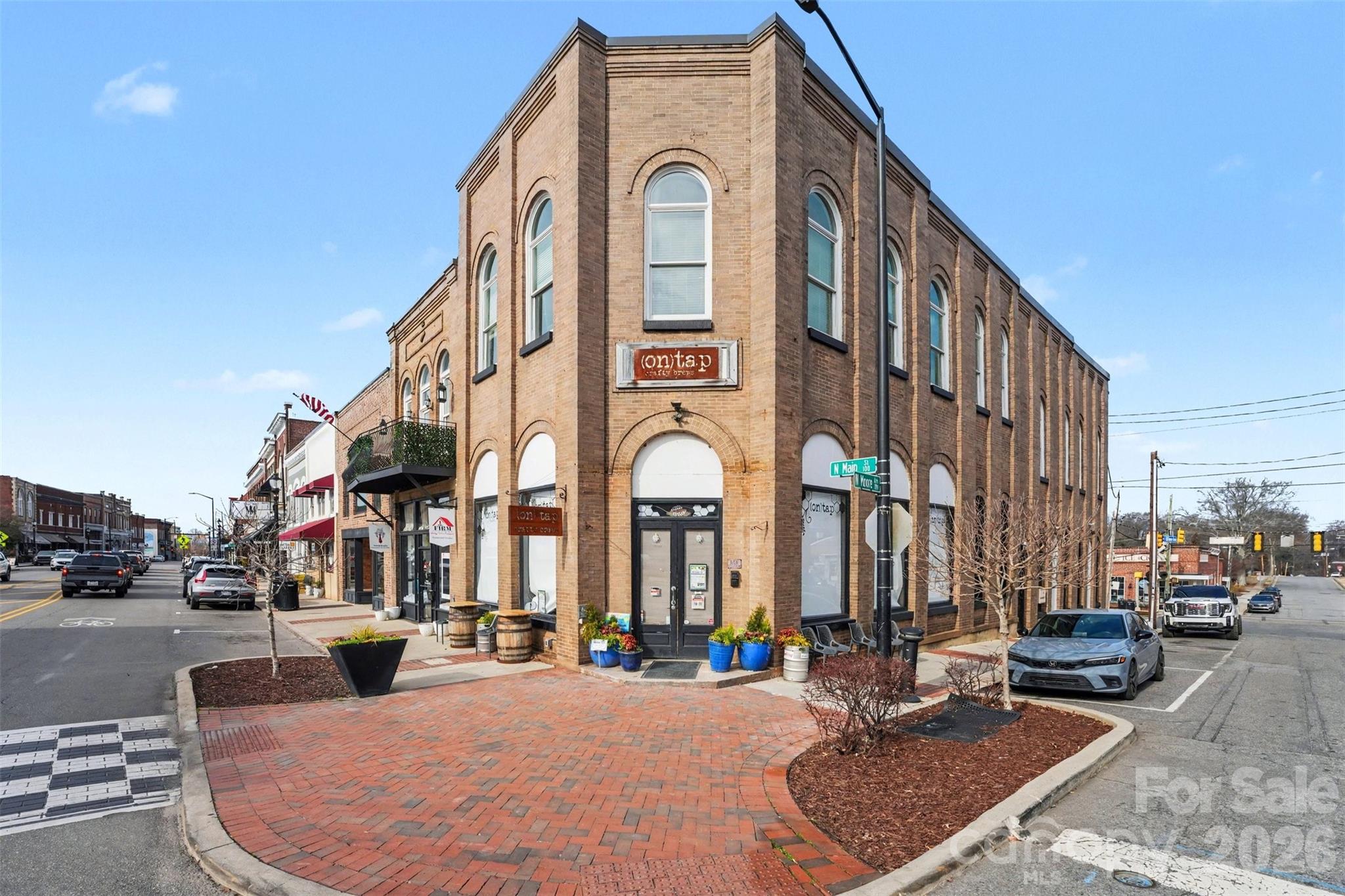 FOR SALE (188 N Main St.) is the entire building including both suites, and featuring the main level tenant beer and wine bar tenant operator celebrating its 7 year anniversary this August 2026- enjoying its current lease of 1,940 SF with a term of 10/1/24 to 8/30/29, one renewal option of an additional 5 years.  Also included in the second floor space currently vacant and last used as office space with an address of 106 W Moore Ave.  This space is this second story walk-up space located on the corner of N Main Street and Moore Street and above 188 N Main St., featuring 1,940SF of heated space. This is a great investment property opportunity. Do not disturb tenant.