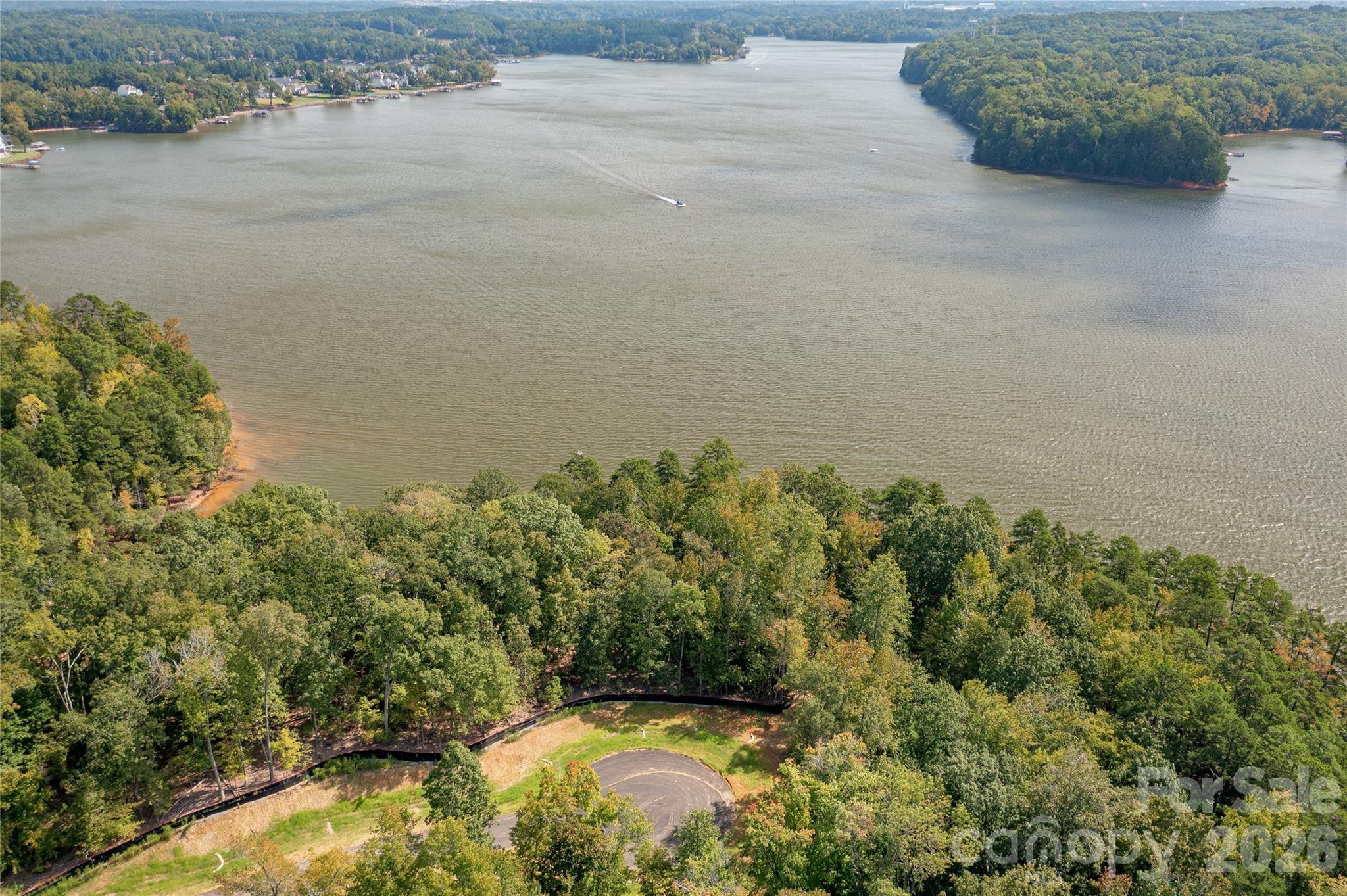 Last cul-de-sac waterfront homesite left on Great Egret - one of the best waterfront locations in all of McLean South Shore - amazing views and privacy on homesite 29. Incredible eastern and southern capturing sites with long views of Lake Wylie. Located on the South Carolina side of South Shore, this level homesite will provide a perfect canvas for your home with at ground views to you pool and outdoor living amenities all with a gorgeous huge lake view. Homesite 29 features 139 feet of lake shoreline to call your own! Nestle your pool by the lake buffer and you can take in the sunshine and incredible main channel lake views. Enjoy South Carolina property taxes at this location too! Bring your home plan to reality with one of our talented approved builders. McLean South Shore offers a clubhouse, outdoor pool, playground, walking trails and a fitness room. McLean is located in the southern section of Belmont where you can access the Carolina Thread Trail which wraps around the lake. You may also enjoy year round activities at the Daniel Stowe Botanical Garden with their ponds, walking trails, dog park, and Trailhead Store with beverages and snacks. Just a short drive into the town of Belmont which features restaurants, coffee shops, Stowe Park where you can enjoy the playground, concerts and other festivities. There is even an active train you can sit and watch. Going to events, restaurants and shopping in greater Charlotte NC is only about 30 minutes away. Want to go somewhere farther away - just a short drive to the Charlotte Douglas International Airport. Bring your waterfront dream to reality in McLean South Shore - come see for yourself the amazing the available homesites!