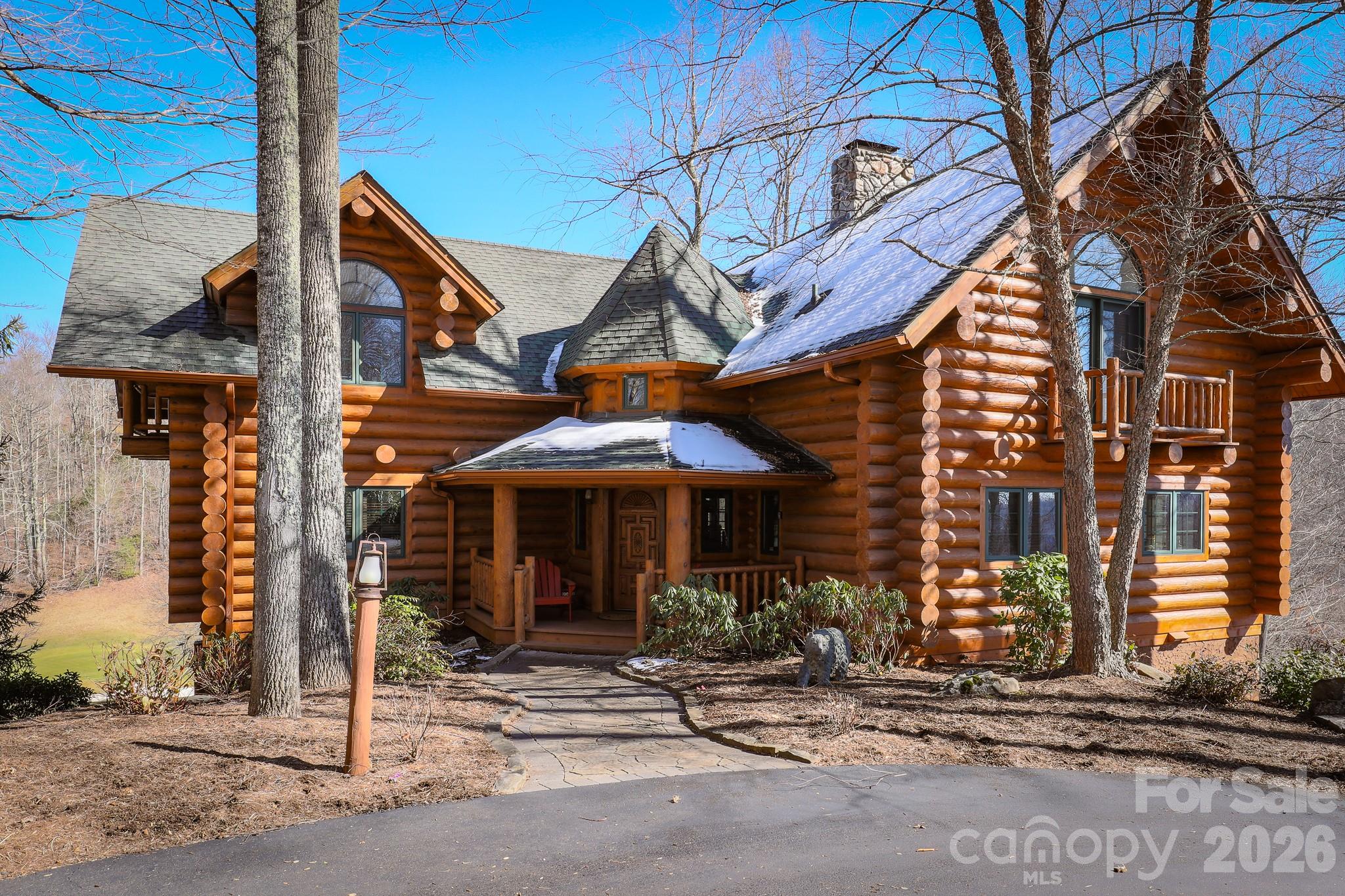 Experience quintessential mountain-top living in this custom-built Alberta Spruce log and timber home, perched at approximately 4,000 ft. in the Austin Mountain community of MOUNTAIN AIR. Overlooking Fairway 15 with long-range mountain views, this stunning 3-level retreat offers the best of both golf and mountain scenery—enjoyable from more than 1,600 sq. ft. of decks and porches. Inside, the home exudes rustic elegance with solid wood floors, exposed beams, and soaring ceilings. River-rock, wood-burning fireplaces with gas starters on both the main and lower levels create warm gathering spaces for family and friends. With 4 spacious bedrooms and 4.5 baths, there’s plenty of room for everyone to relax and unwind. Seller may be willing to pay up to $50,000 of the buyer's initiation fee towards a full golf membership at closing with an acceptable offer. Whether you’re seeking a serene escape or a welcoming home for entertaining, this beautifully crafted log residence delivers the perfect mountain getaway. Don’t miss the opportunity to make this remarkable home your own!