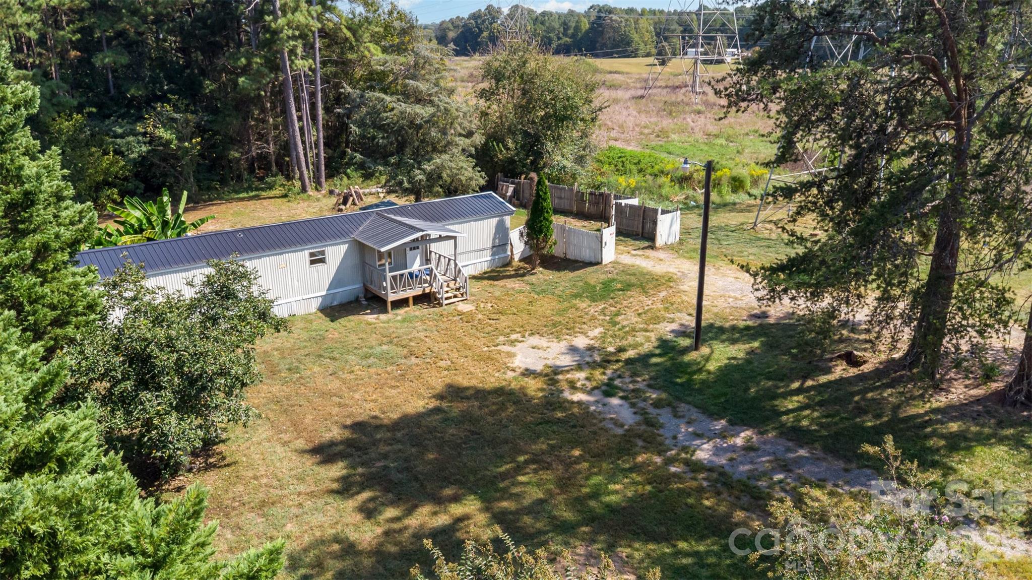 Set on an expansive 1.38-acre homesite, this property offers a rare opportunity to enjoy wide-open space, privacy, and a peaceful rural setting while still being within reach of everyday conveniences. Surrounded by mature trees and natural landscape, the setting creates a quiet retreat with plenty of room to spread out, garden, or simply enjoy the outdoors.

The home sits comfortably on the lot with a welcoming presence, complemented by a large yard that invites endless possibilities. Whether you envision outdoor entertaining, adding additional structures, or creating your own personal oasis, the generous acreage provides the flexibility to make it your own. A deck extends the living space outdoors, offering the perfect spot to relax and take in the serene surroundings.

Inside, the layout is functional and easy to navigate, with a cozy living area that flows into the kitchen and dining space. Natural light enhances the interior, while the overall design supports simple, comfortable living.

With its combination of usable land, tree-lined privacy, and laid-back country feel, this property stands out as an excellent opportunity for those seeking space and potential in a quiet York County setting.
