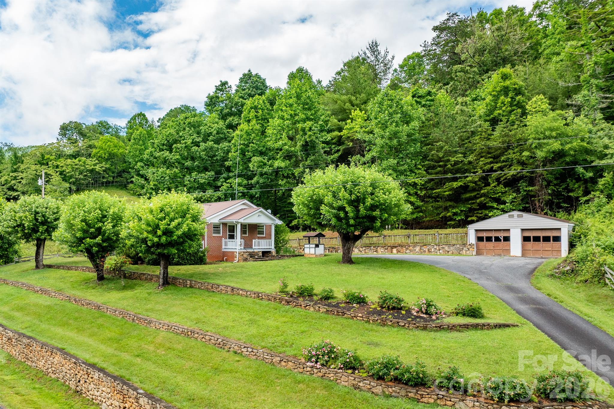 Opportunity awaits on 7.35 unrestricted acres in a peaceful, serene setting. This solid brick home is ready for your vision and restoration. Much of the home remains original, offering the chance to update and customize the property. Tucked into a quiet rural setting with room for gardens, animals, and recreation. This property offers privacy, usable land, and beautiful mountain surroundings. Conveniently located approximately 15 minutes to downtown Marshall, 25 minutes to Weaverville, and 40 minutes to Asheville, allowing you to enjoy a peaceful mountain setting while still being within easy reach of everyday conveniences.