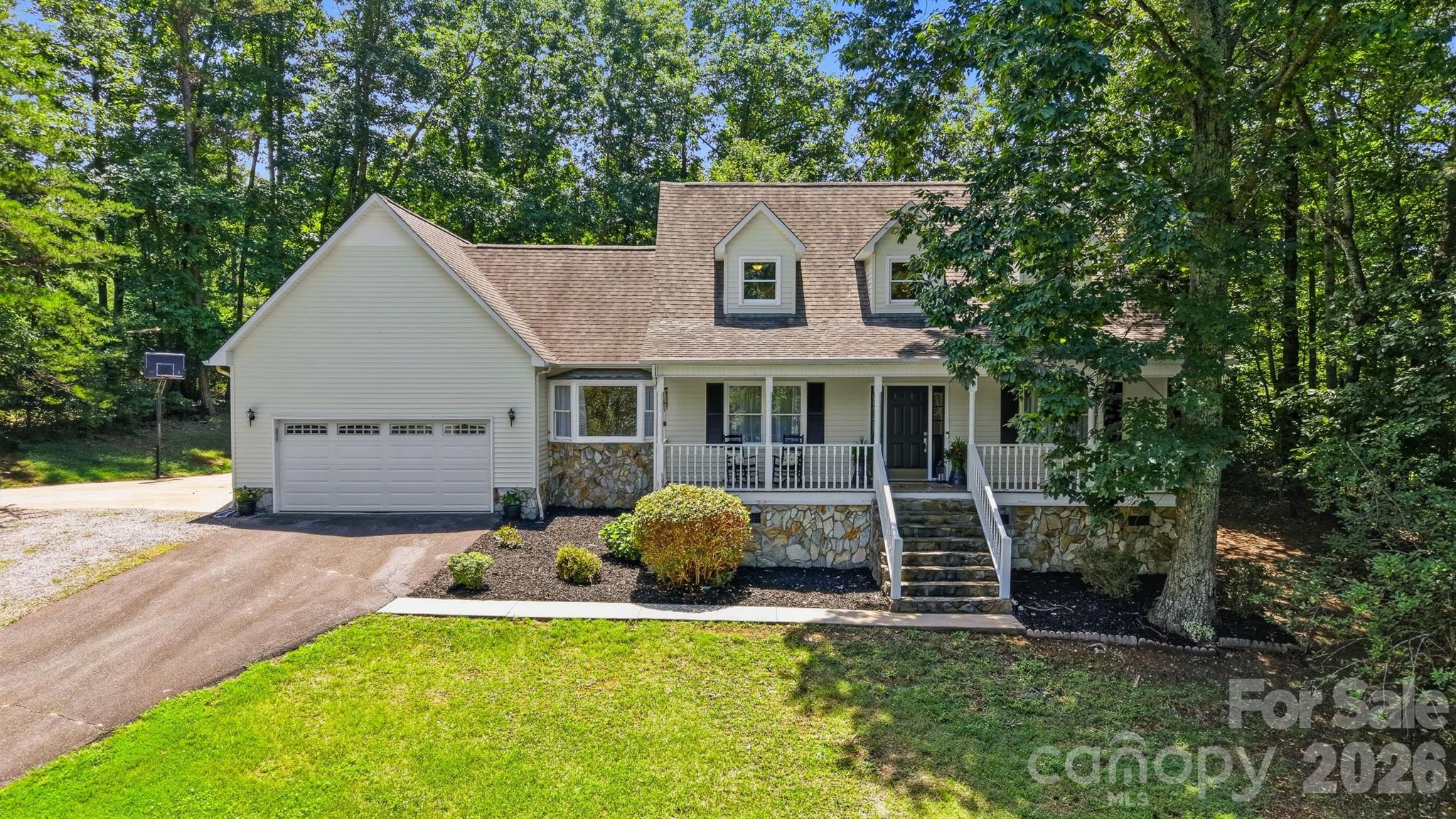 From the moment you wind through the trees and pull into the driveway, you'll feel the stress of the day begin to melt away. Tucked into a peaceful, wooded setting, this charming Cape Cod invites you to slow down, sip your morning coffee on the front porch, and enjoy the quiet beauty that surrounds you. Inside, warm wide plank hardwood floors, fresh paint, updated lighting and thoughtfully refreshed spaces create a home that feels both timeless and move-in ready. The heart of the home is the bright, inviting kitchen where the family meals, and conversations naturally come together. Upstairs, you'll find three nice size bedrooms with plenty of closet space and two beautifully remodeled bathrooms with new tub and shower surrounds, refreshed cabinetry, modern fixtures and new premium plank flooring in all the bathrooms. Need Flexibility? The finished room and a full bath on the main level offers a great guest retreat. Home is served by a 3-bedroom septic system. The previous owner added the additional room and bathroom, but the septic permit remains for three bedrooms.