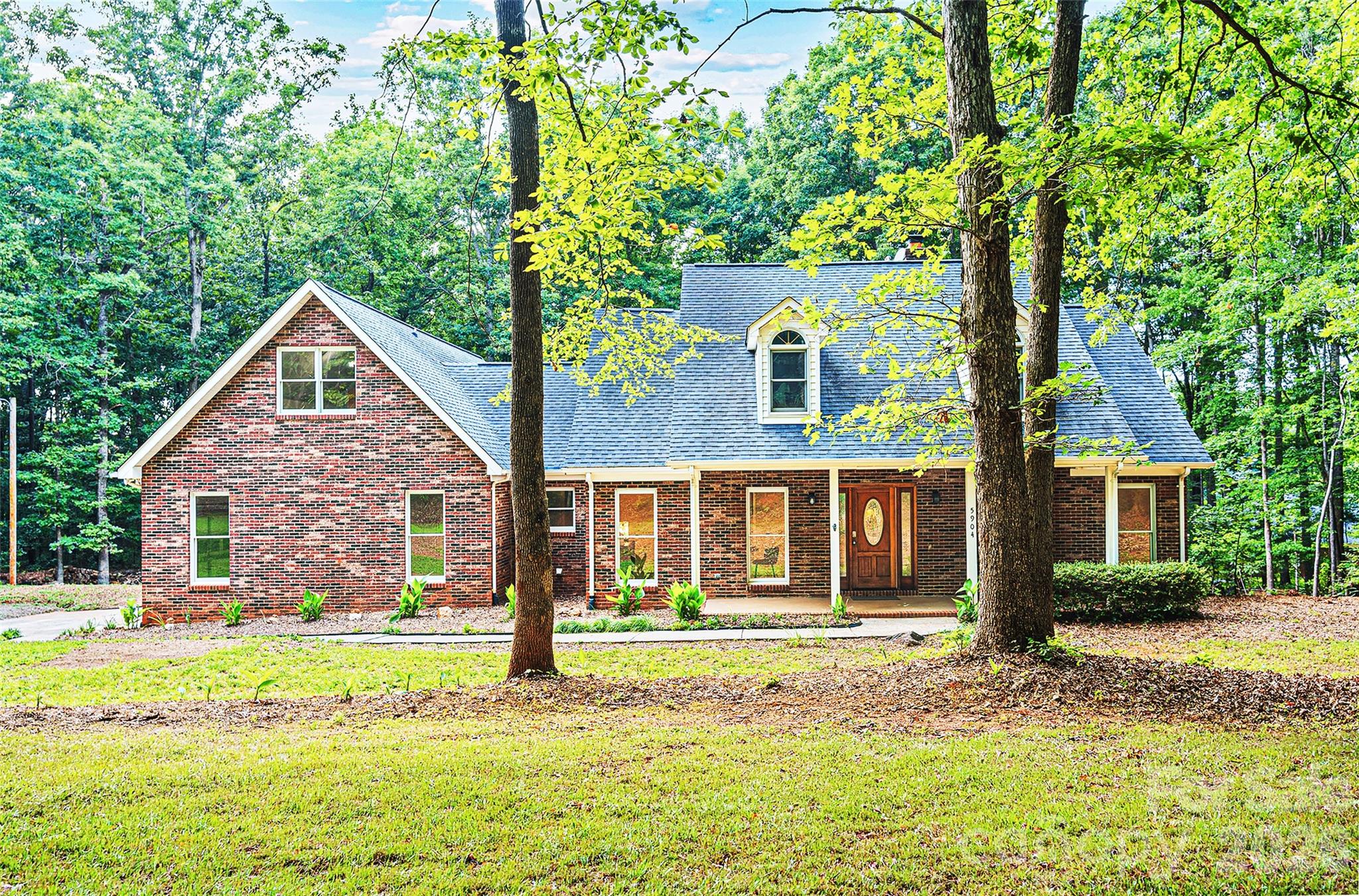 Beautifully updated all-brick home nestled on 3.5 private acres, offering the perfect blend of modern upgrades and timeless charm. This spacious home features 4 bedrooms, 3.5 baths and a large bonus room that can be used as a 5th bedroom. Fresh paint and new LVP flooring throughout. The fully renovated kitchen boasts all brand-new appliances, quartz countertops, a new kitchen island, and a new range hood. New quartz countertops in all bathrooms. Primary bath completely remodeled with new walk-in shower, free-standing tub and new vanity. Upstairs new walk-in shower. The living room features soaring cathedral ceilings and a cozy wood-burning fireplace. Major updates include new HVAC systems (lower unit 2026, upper unit 2022) and a roof replaced in 2016. Step outside to enjoy the large freshly stained deck overlooking the peaceful acreage — perfect for entertaining or relaxing. This home is truly a one-of-a-kind and completely ready for its new owner!