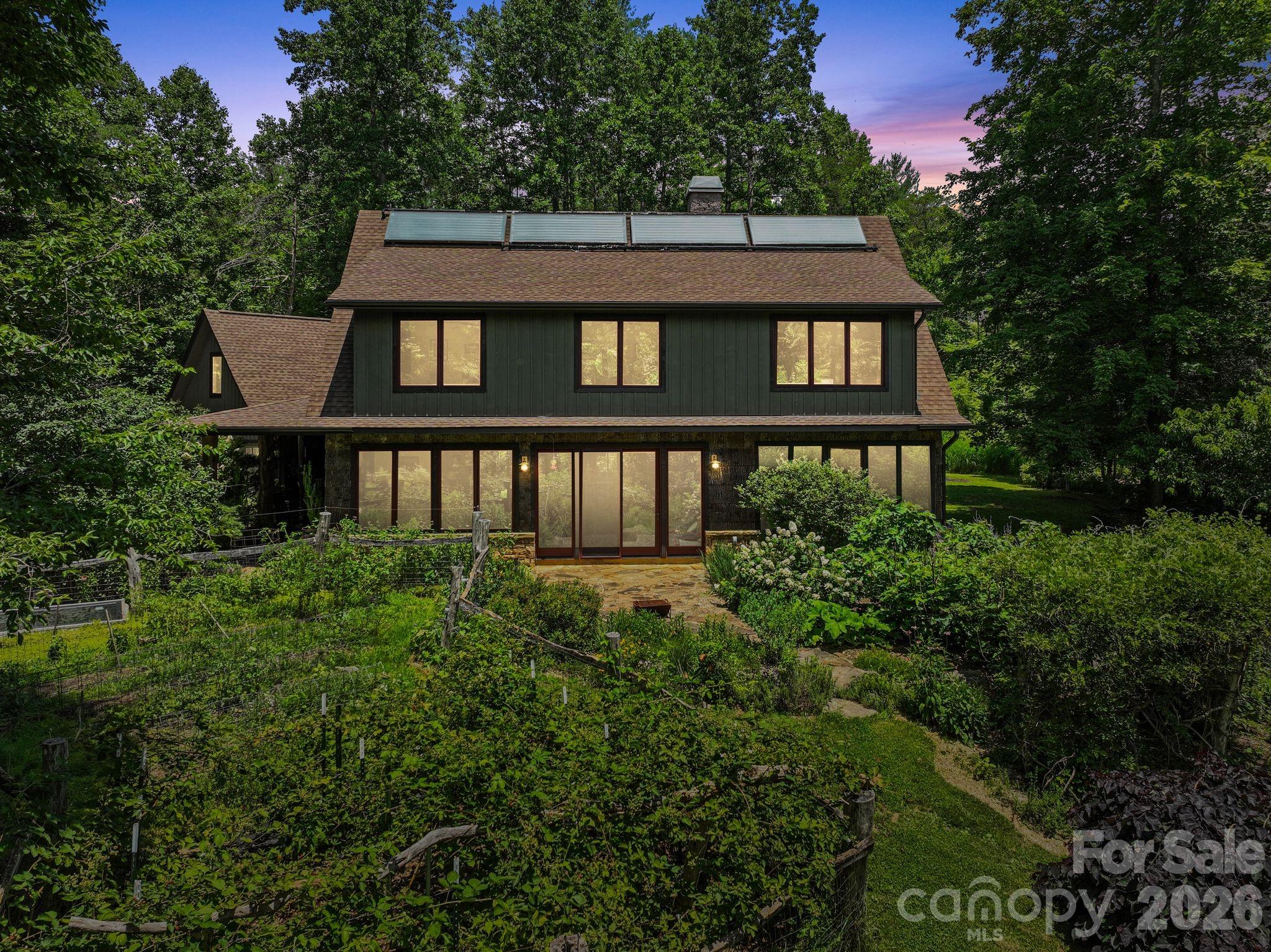 A rare opportunity to own a one-of-a-kind, artisan-built home where sustainable living meets natural beauty. Tucked into the landscape of the Riverwind subdivision, this 2,594 sq ft two-story residence is a showcase of traditional timber frame joinery and thoughtful craftsmanship. Remarkably, nearly every piece of wood in the home was harvested directly from the land it stands on.
The natural poplar bark siding, exposed timber frame structure, hardwood floors, and custom-built closets were all milled from trees felled on the property itself, a level of intentionality rarely seen in residential construction. The result is a home that is genuinely of its place, with a warmth and authenticity no showroom material could replicate.
Inside, the open-concept main level is bathed in natural light through walls of oversized wood-framed casement windows, with polished concrete floors, a chef's kitchen with generous counter space, and a wood stove that anchors the living area. The soaring exposed beam ceilings and hand-fitted joinery tell the story of the land in every room, creating an interior that feels both earthy and refined.
The upper level offers multiple bedrooms, generous closet space, and treehouse-like views into the surrounding canopy. Outside, the 2.26-acre property features lush perennial gardens, mature plantings, a flagstone patio, and open pasture. The grounds offer ample room for additional structures, the next owner exceptional flexibility to expand and personalize the property.
This home was built with genuine intention toward sustainable living. A passive solar Trombe wall works quietly alongside the rooftop solar panels to regulate interior temperatures naturally, minimizing heating demands and keeping energy bills impressively low year-round. This property offers clean air, good bones, and a home that is truly rooted in the land it was built from. Please no drive bys.